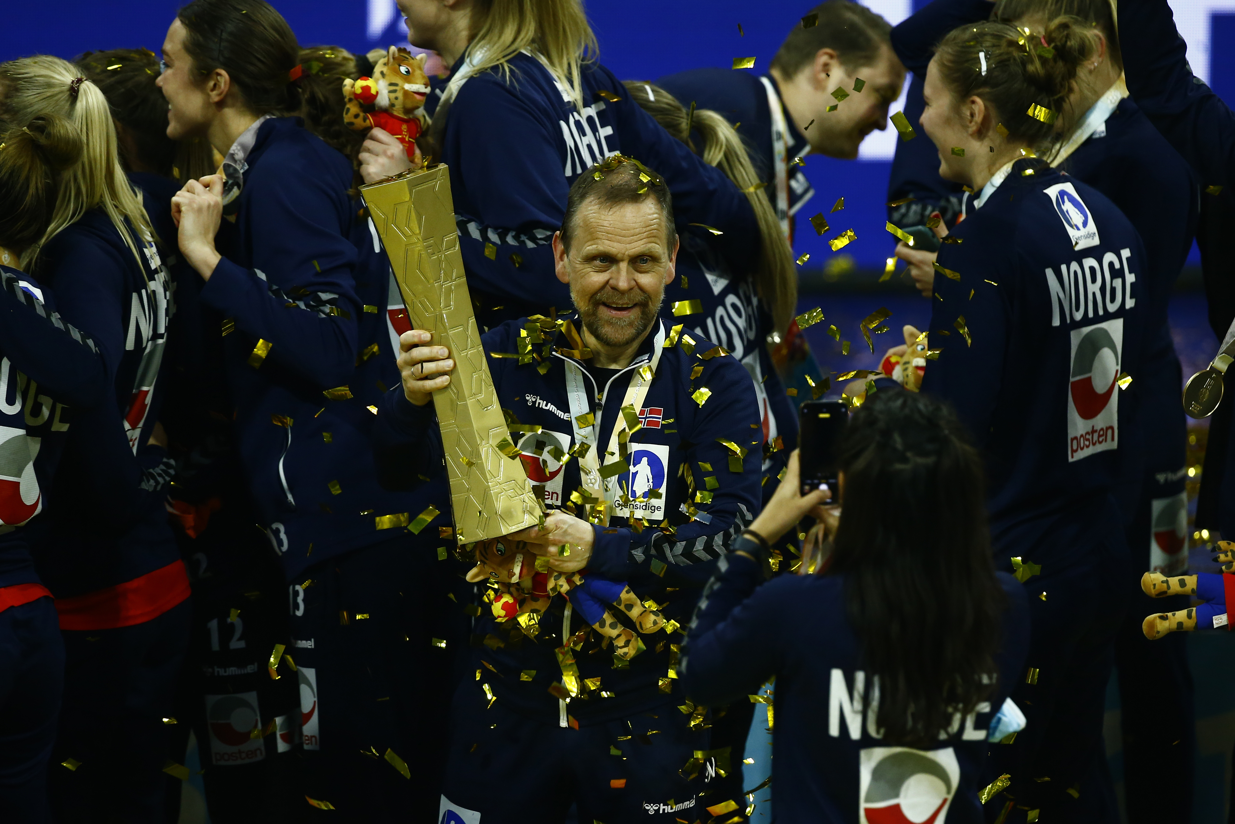 Norway's coach Thorir Hergueirsson holds the trophy after beating France during the final of the Women's Handball World Championship in Granollers, Spain, Sunday, Dec. 19, 2021. (AP Photo/Joan Monfort)