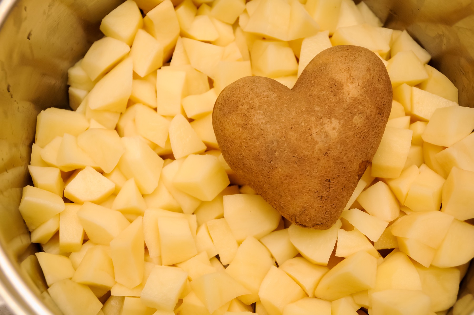 A heart potato among chopped potatoes in a pan,Image: 335662726, License: Royalty-free, Restrictions: , Model Release: no, Credit line: Caleb Harper / Panthermedia / Profimedia