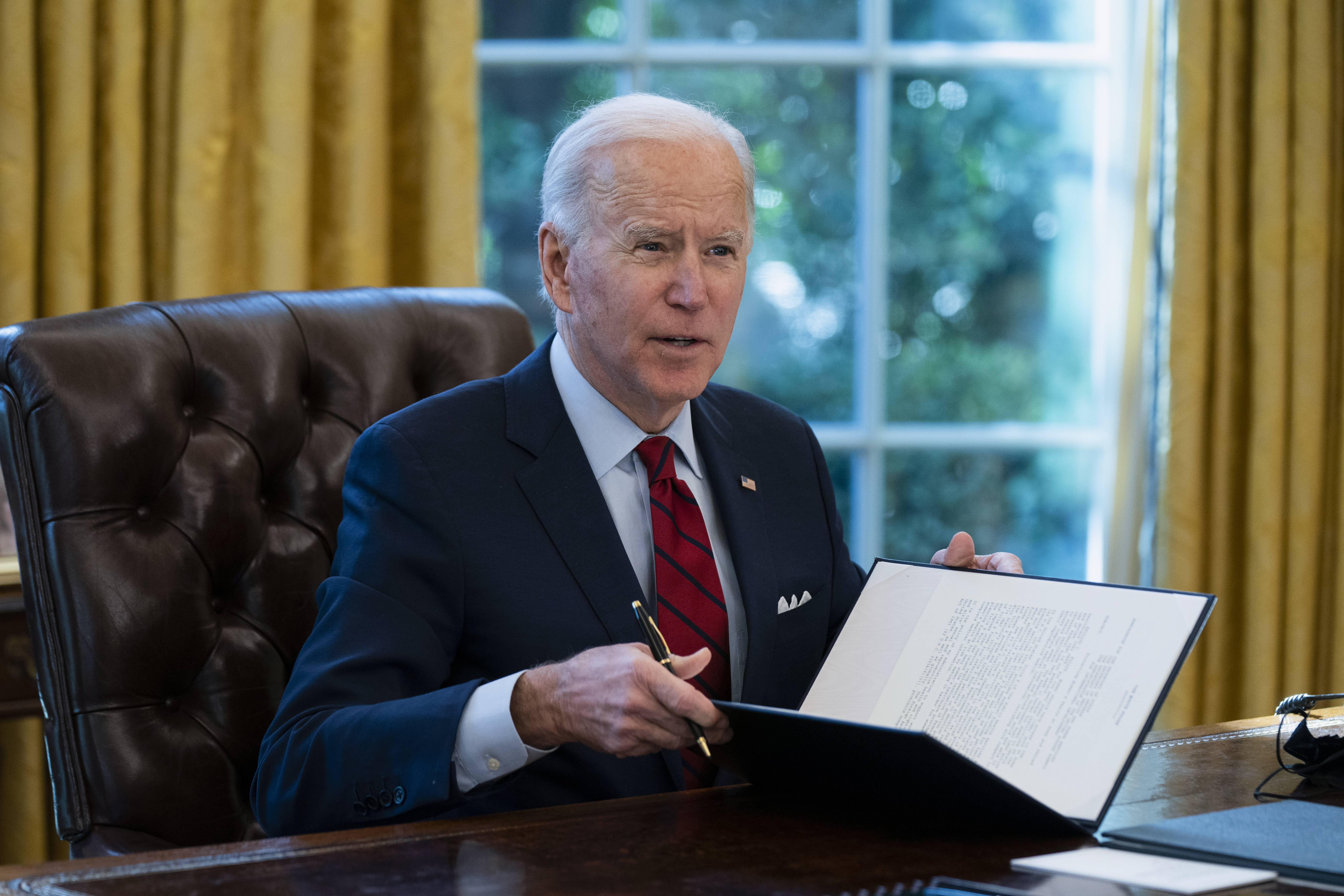 President Joe Biden signs a series of executive orders on health care, in the Oval Office of the White House, Thursday, Jan. 28, 2021, in Washington. (AP Photo/Evan Vucci)