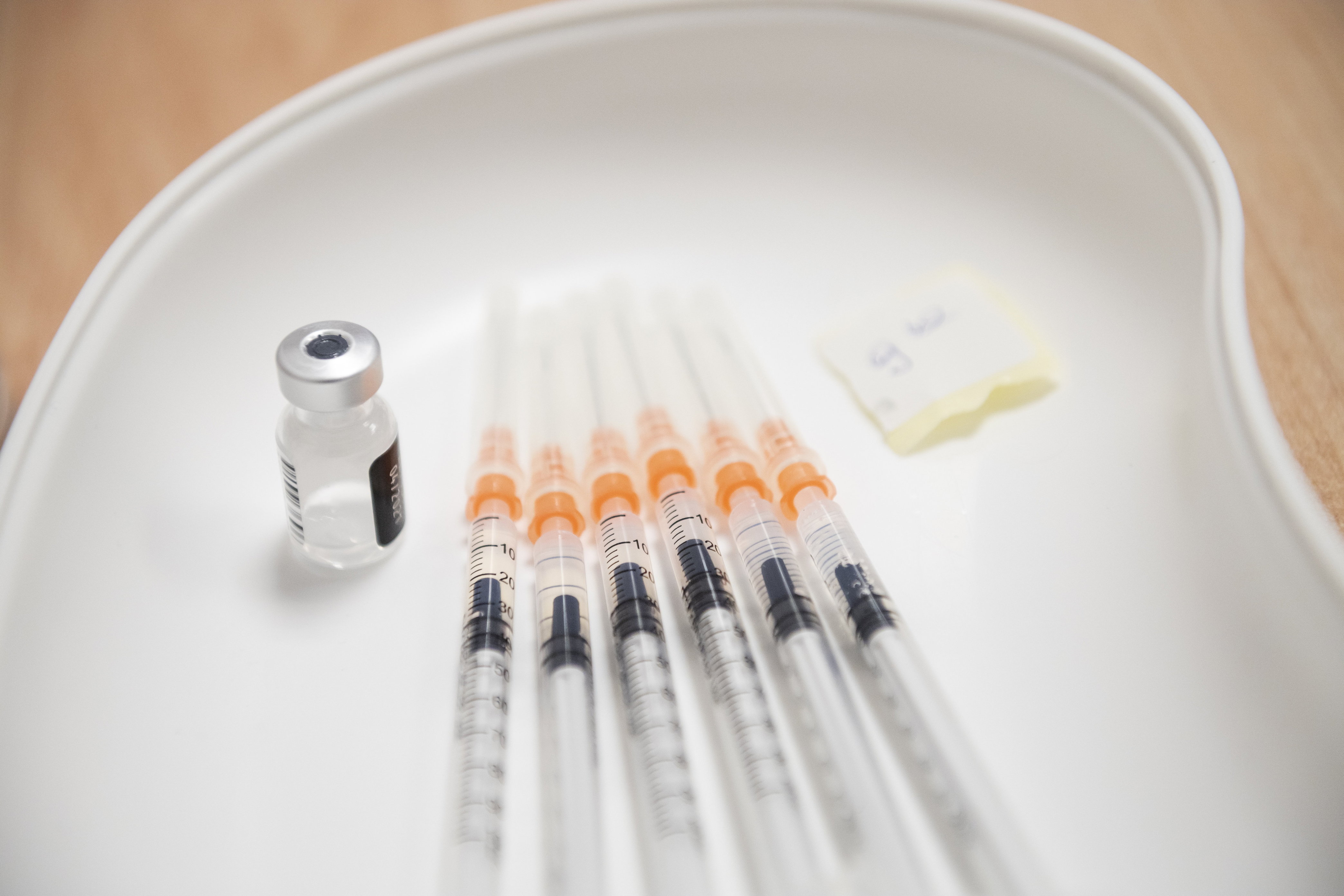 epa08961958 Syringes are filled with Pfizer-BioNTech vaccine against the coronavirus disease (COVID-19), at the Szent Imre University Teaching Hospital in Budapest, Hungary, 24 January 2021.  EPA-EFE/MARTON MONUS HUNGARY OUT