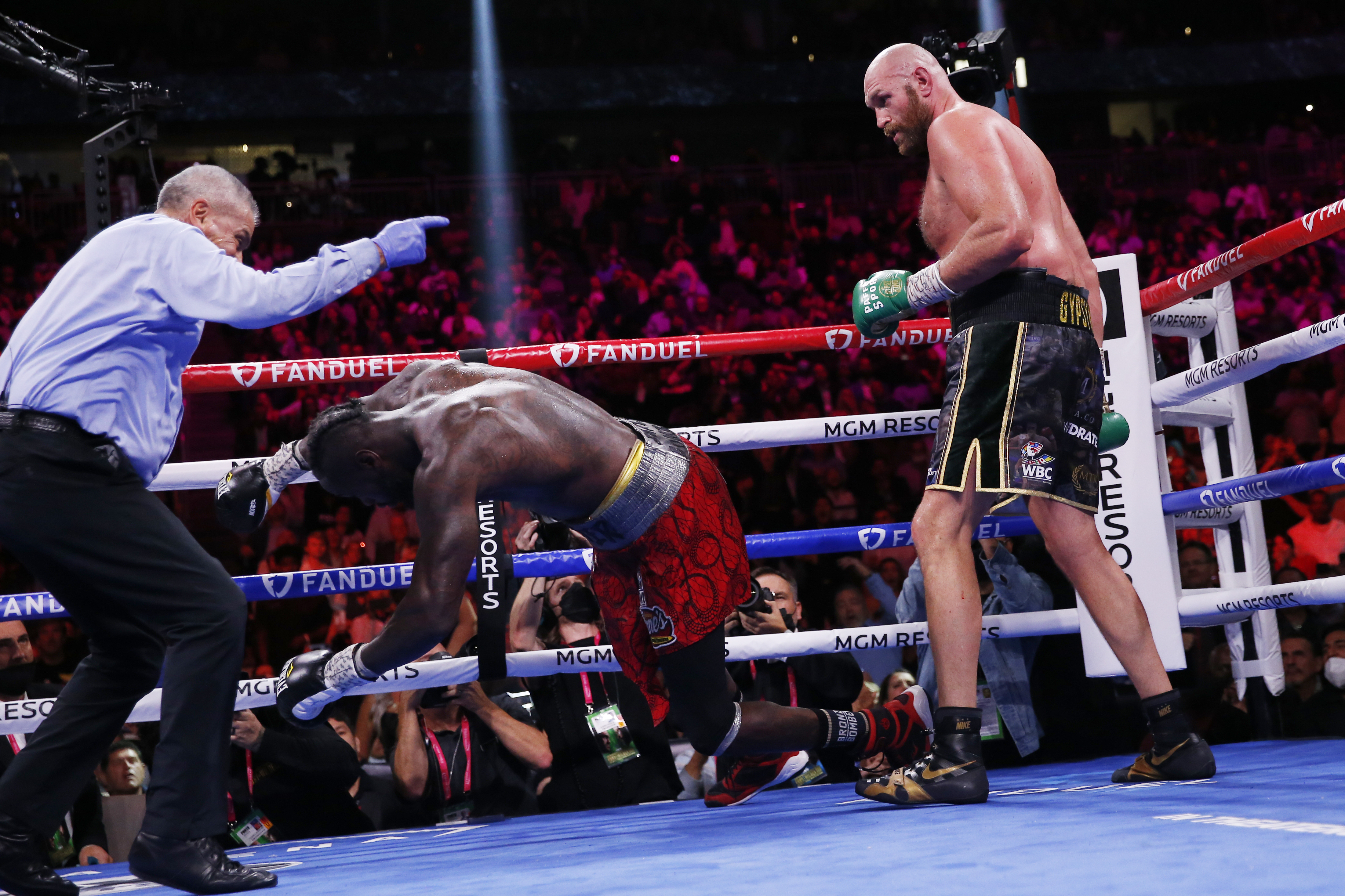Tyson Fury, of England, knocks out Deontay Wilder to win in the 11th round in a heavyweight championship boxing match Saturday, Oct. 9, 2021, in Las Vegas. (AP Photo/Chase Stevens)