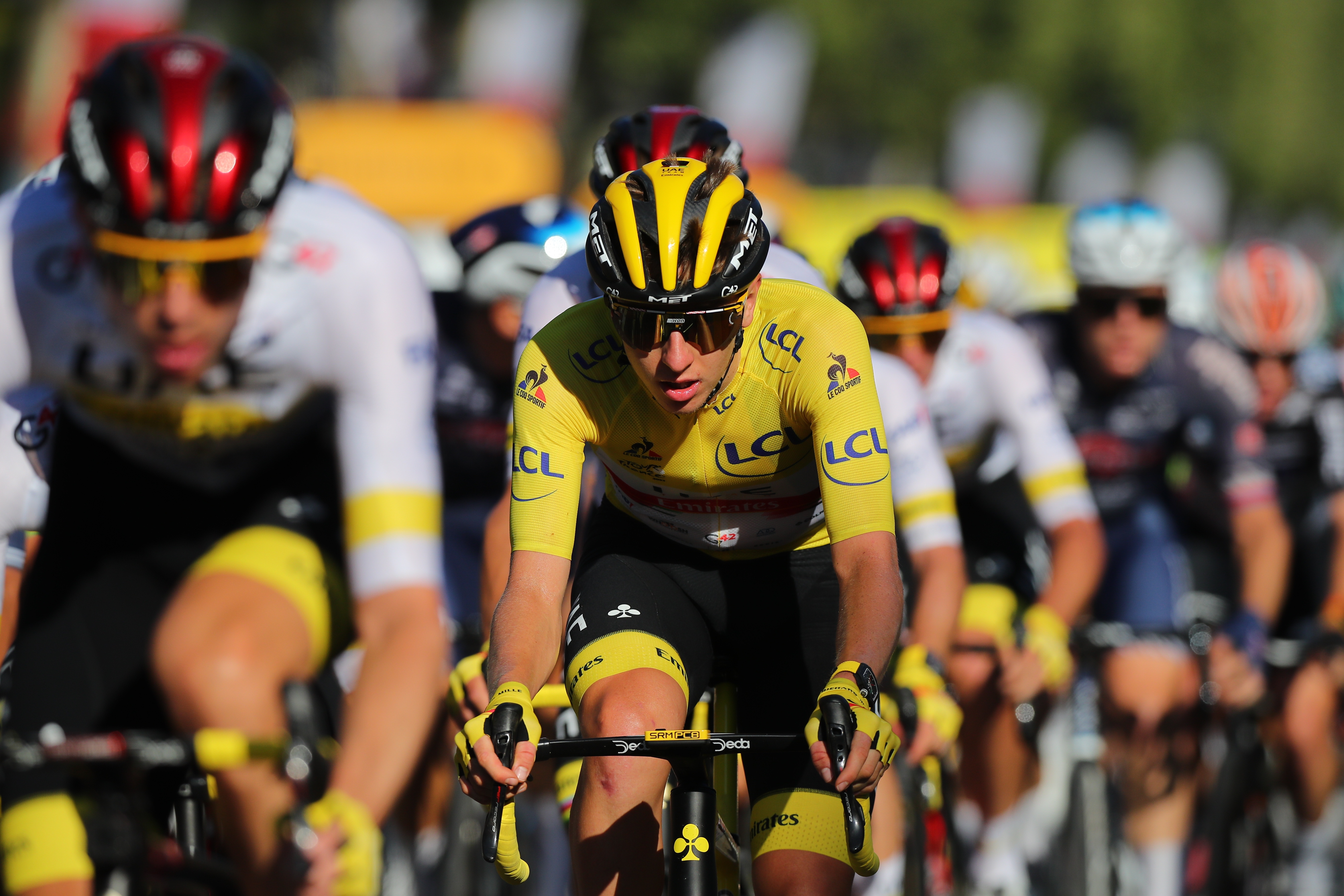 epa09352300 Slovenian rider Tadej Pogacar (C) of the UAE-Team Emirates wears the overall leader's yellow jersey during the 21st stage of the Tour de France 2021 over 108.4 km from Chatou to Paris, France, 18 July 2021.  EPA-EFE/CHRISTOPHE PETIT-TESSON
