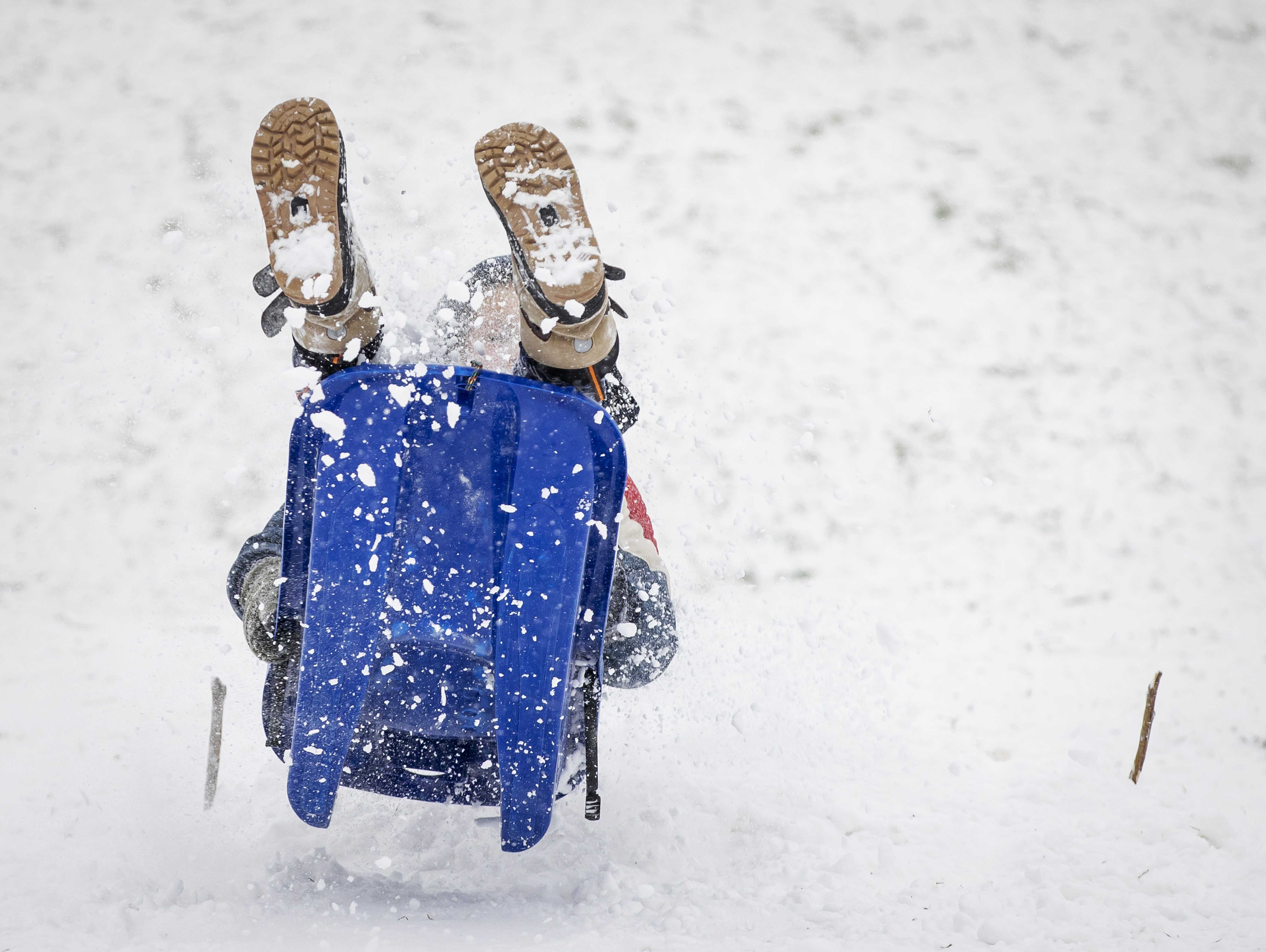 epa08993827 Children enjoy sledding in the snow in the Griftpark in Utrecht, The Netherlands, 07 February 2021. After ten years there is officially a snow storm in The Netherlands.  EPA-EFE/ROBIN VAN LONKHUIJSEN