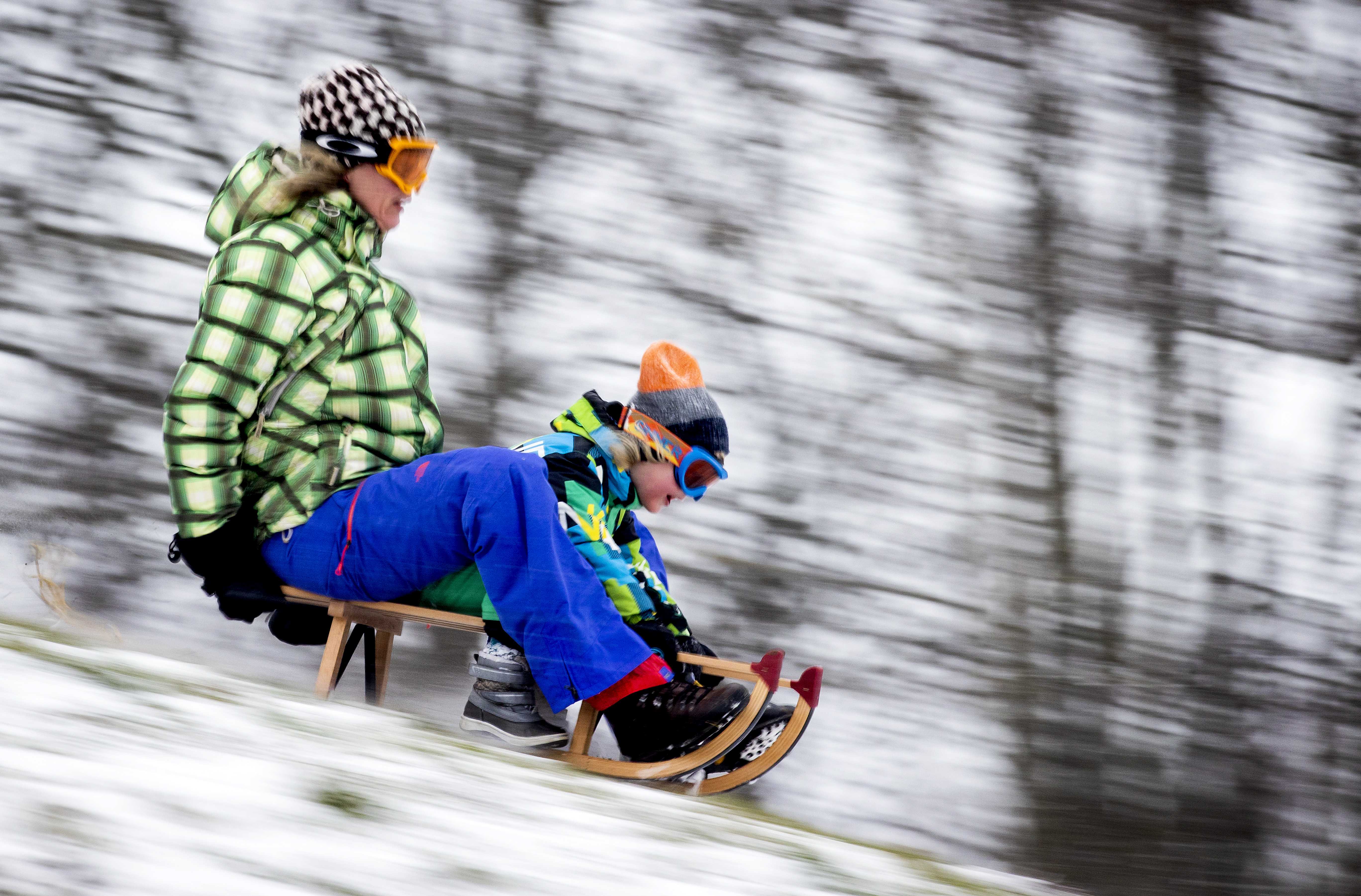 epa08993243 Children and adults enjoy sledding in the snow in Heiloo, The Netherlands, 07 February 2021. After ten years there is officially a snow storm in The Netherlands.  EPA-EFE/KOEN VAN WEEL
