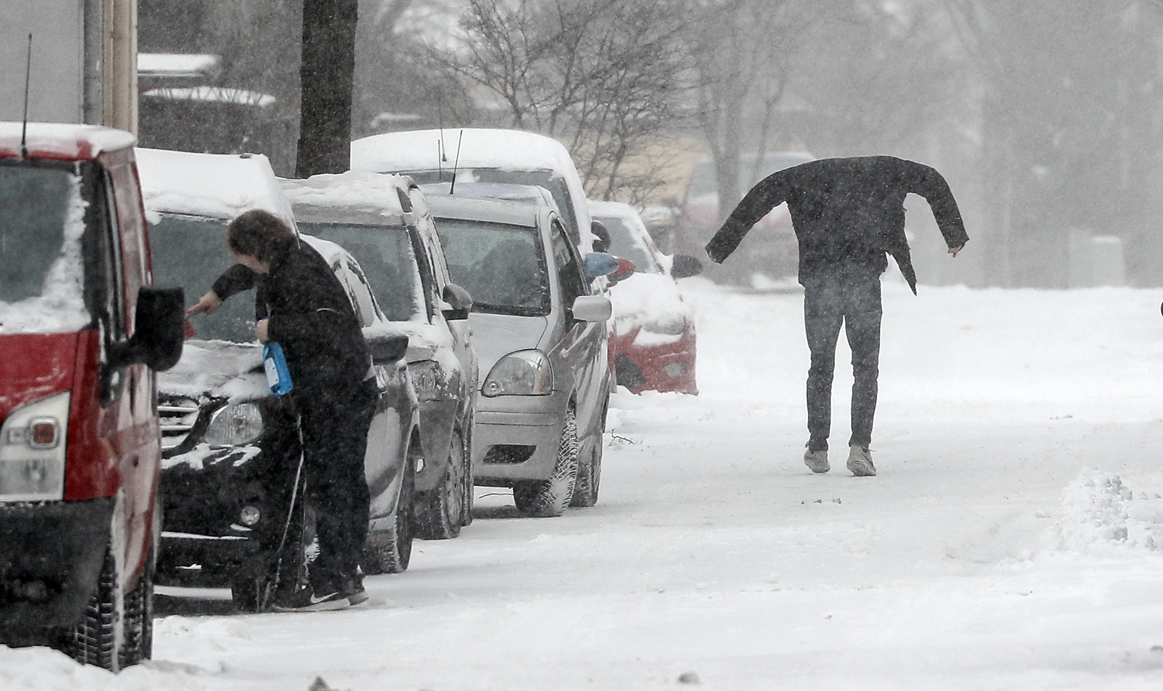 A man walks on a snowy street in Gelsenkirchen, Germany, Monday, Feb. 8, 2021. Parts of Germany are hit by strong winter weather. (AP Photo/Martin Meissner)