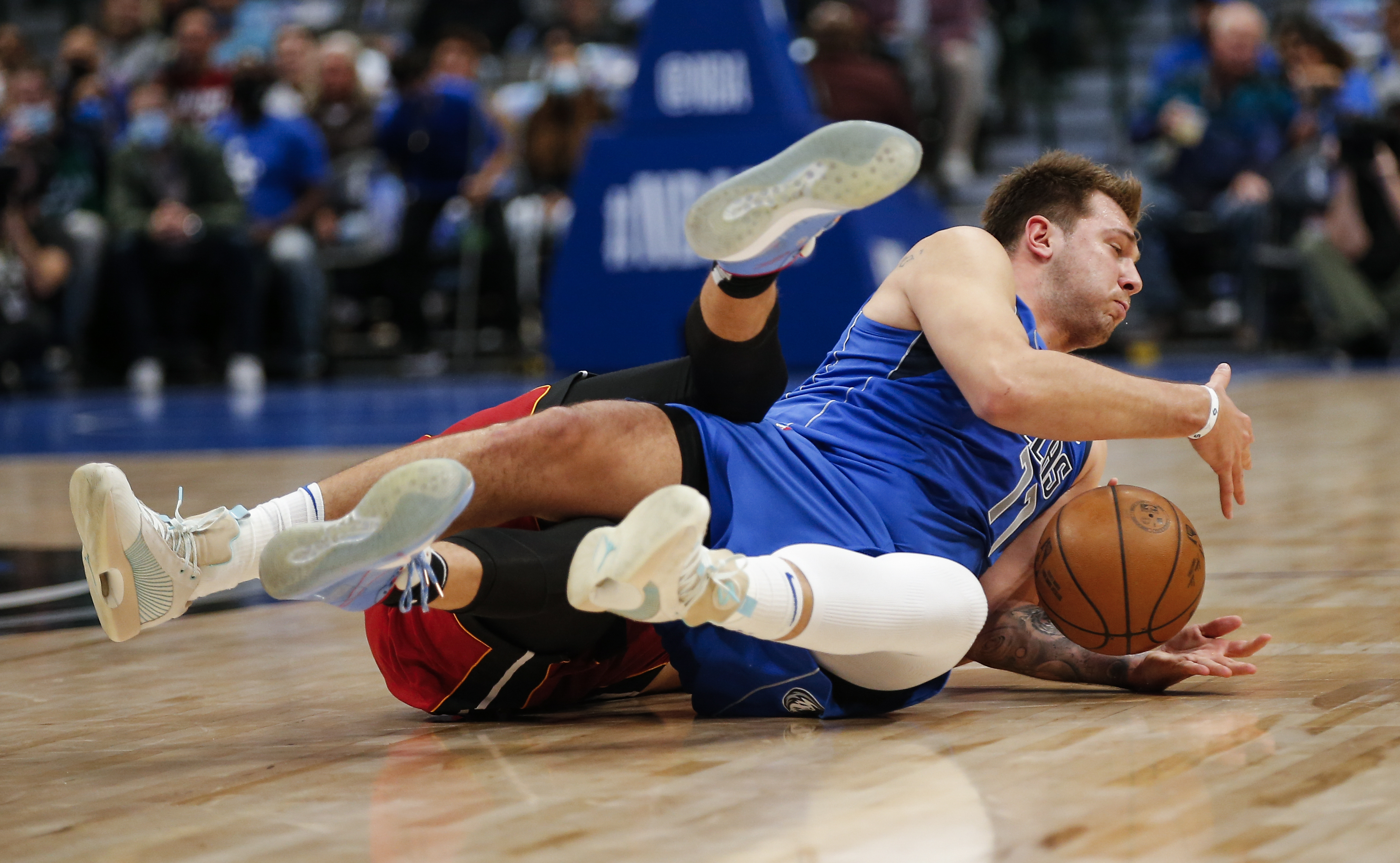 Dallas Mavericks guard Luka Doncic, right, vies with Miami Heat guard Duncan Robinson for the ball during the first half of an NBA Basketball game Tuesday, Nov. 2, 2021, in Dallas. (AP Photo/Brandon Wade)