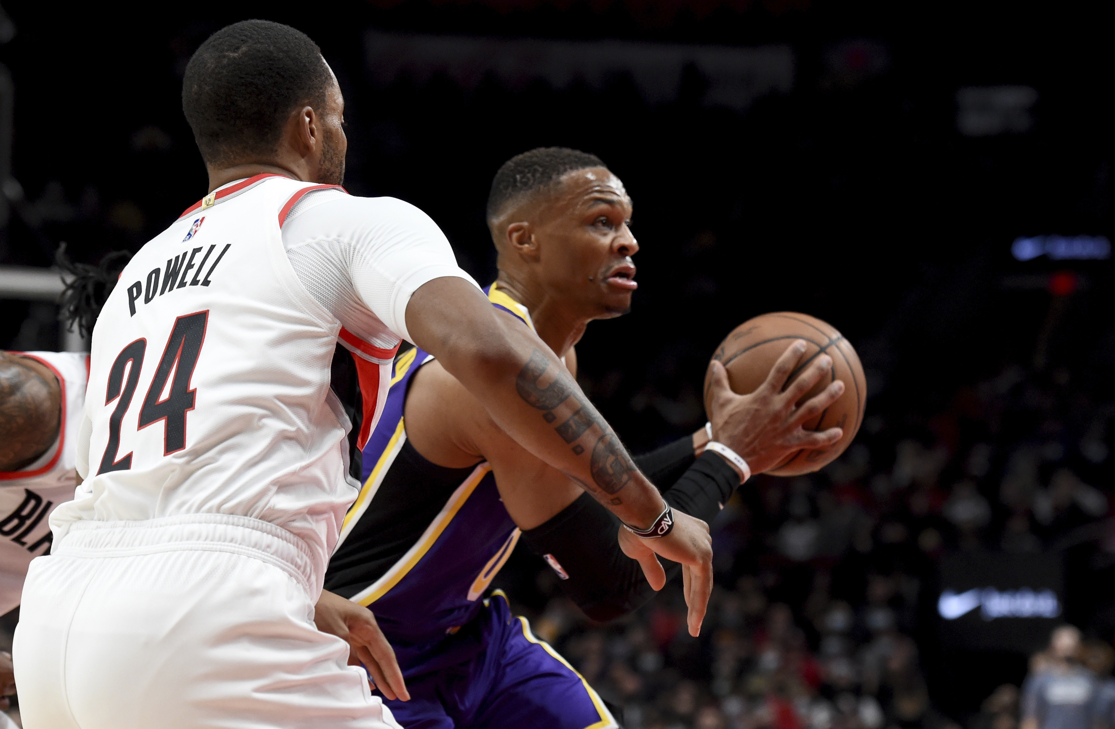 Los Angeles Lakers guard Russell Westbrook, right, drives to the basket on Portland Trail Blazers forward Norman Powell, left, during the first half of an NBA basketball game in Portland, Ore., Saturday, Nov. 6, 2021. (AP Photo/Steve Dykes)