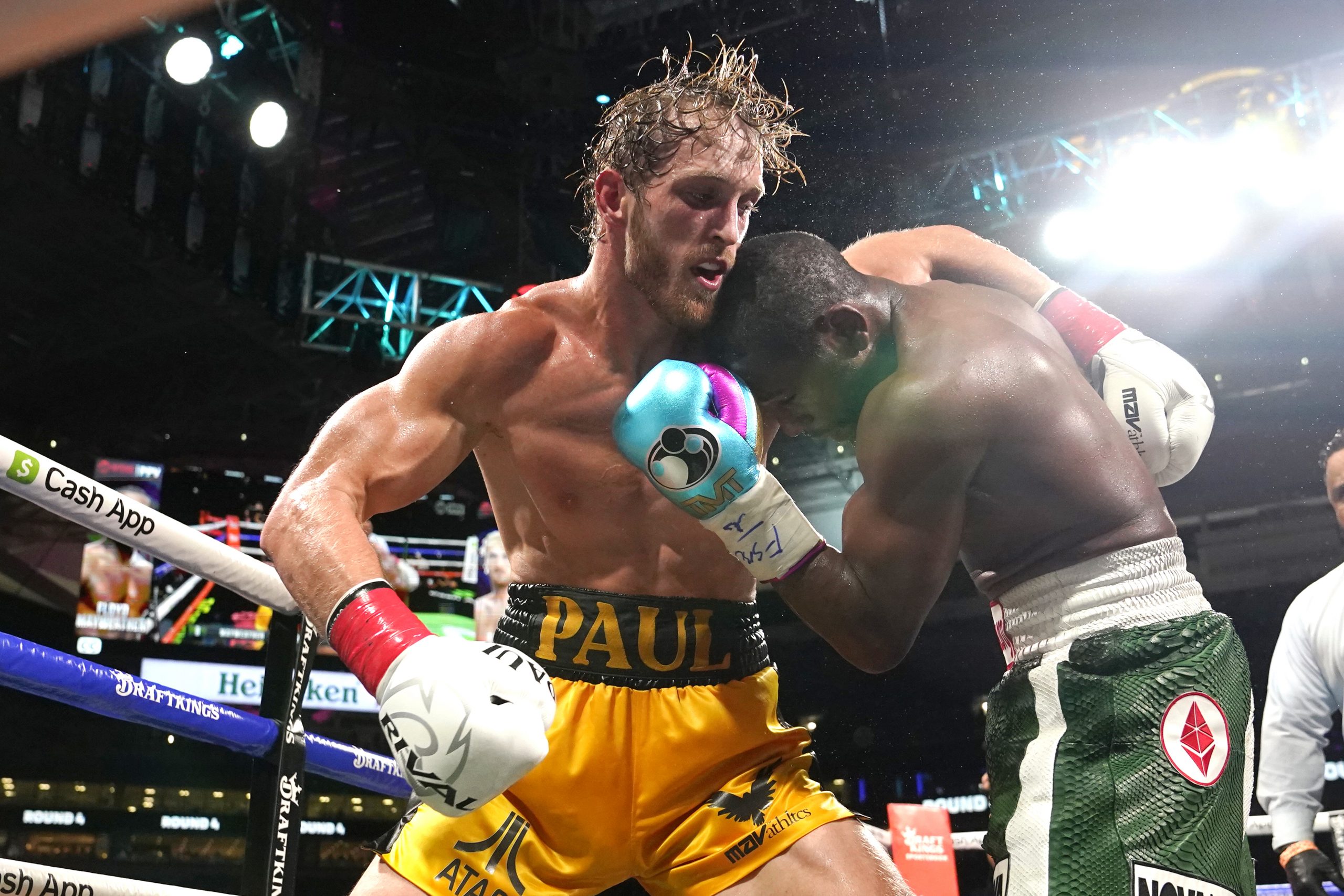 Logan Paul, left and Floyd Mayweather fight during an exhibition boxing match at Hard Rock Stadium, Sunday, June 6, 2021, in Miami Gardens, Fla. (AP Photo/Lynne Sladky)