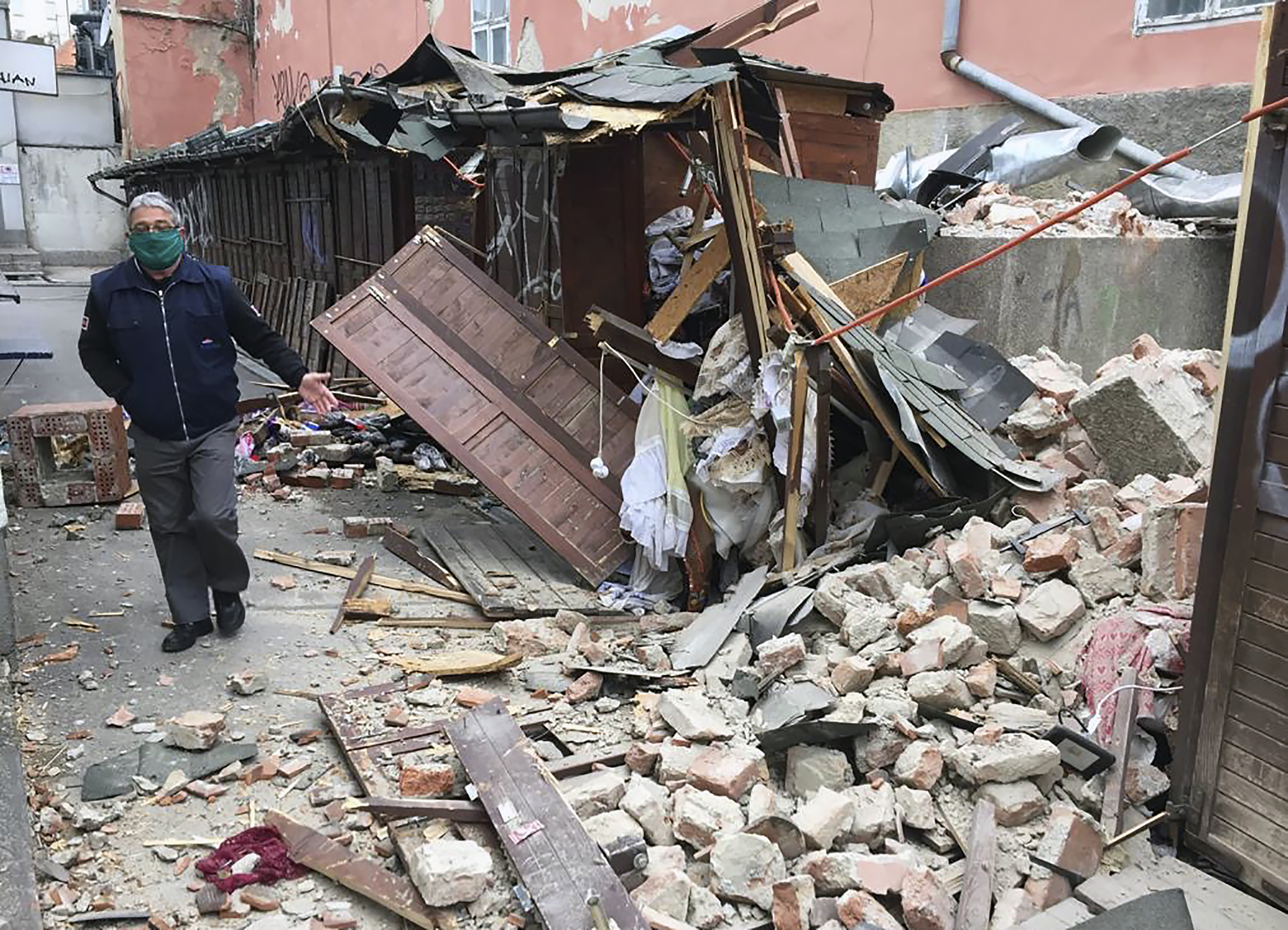 A man inspects the damage caused by an earthquake in Zagreb, Croatia, Sunday, March 22, 2020. A strong earthquake shook Croatia and its capital on Sunday, causing widespread damage and panic. (AP Photo/Filip Horvat)