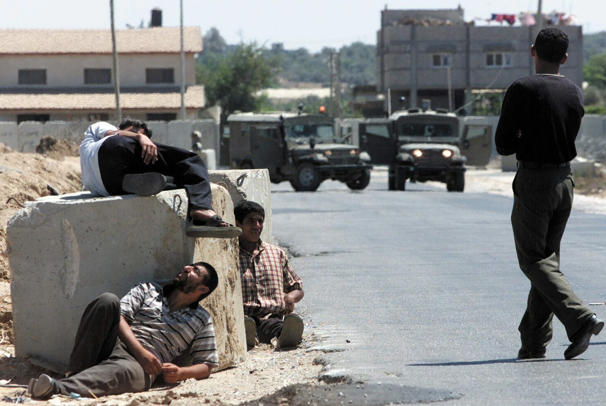 PALESTINIAN MEN REST AT CHECKPPOINT