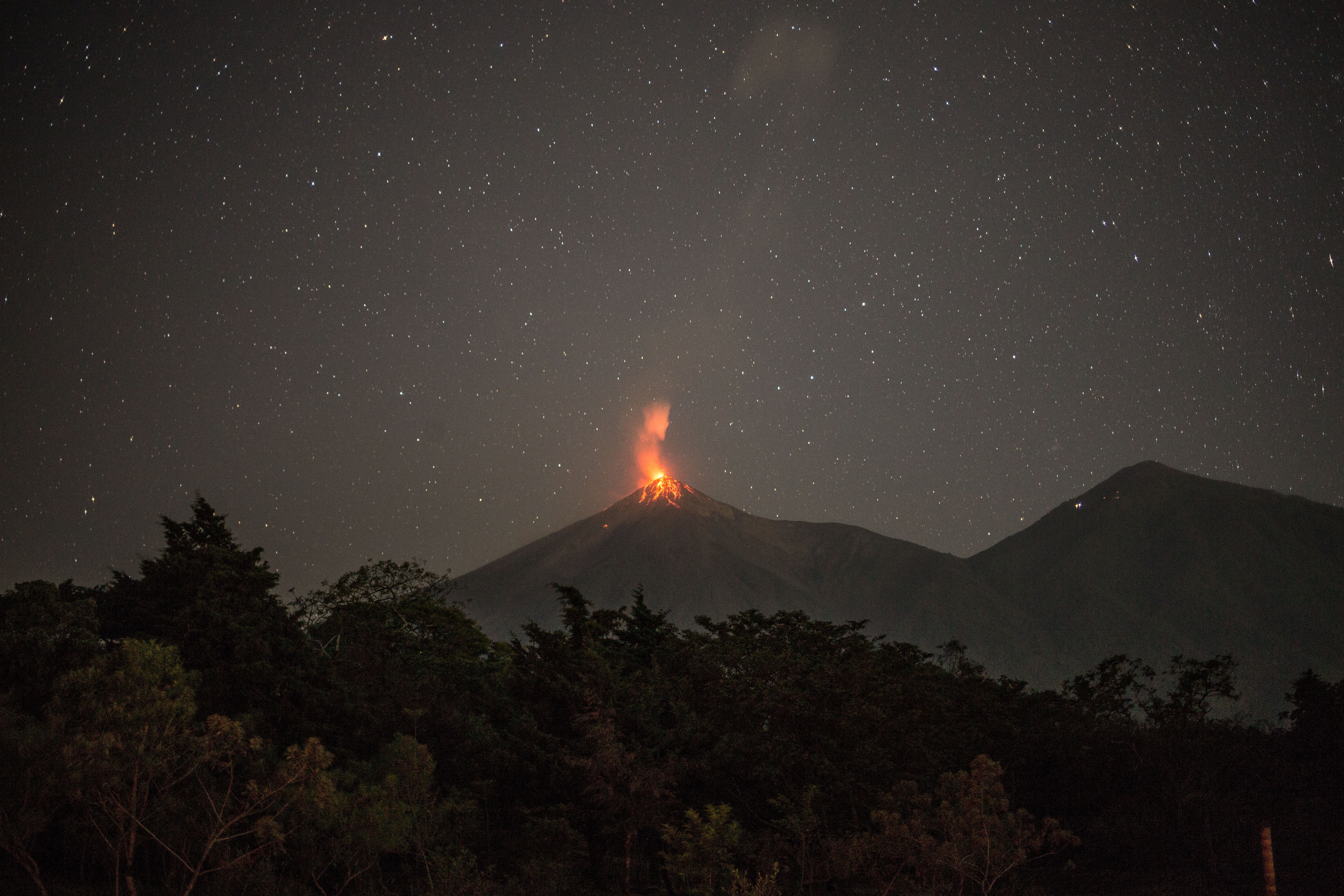 epaselect epa09013475 View of the eruption of Volcan de Fuego as seen from Alotenango, Guatemala, 14 February 2021. The volcano erupted on 14 February generating pyroclastic flows.  EPA-EFE/Esteban Biba