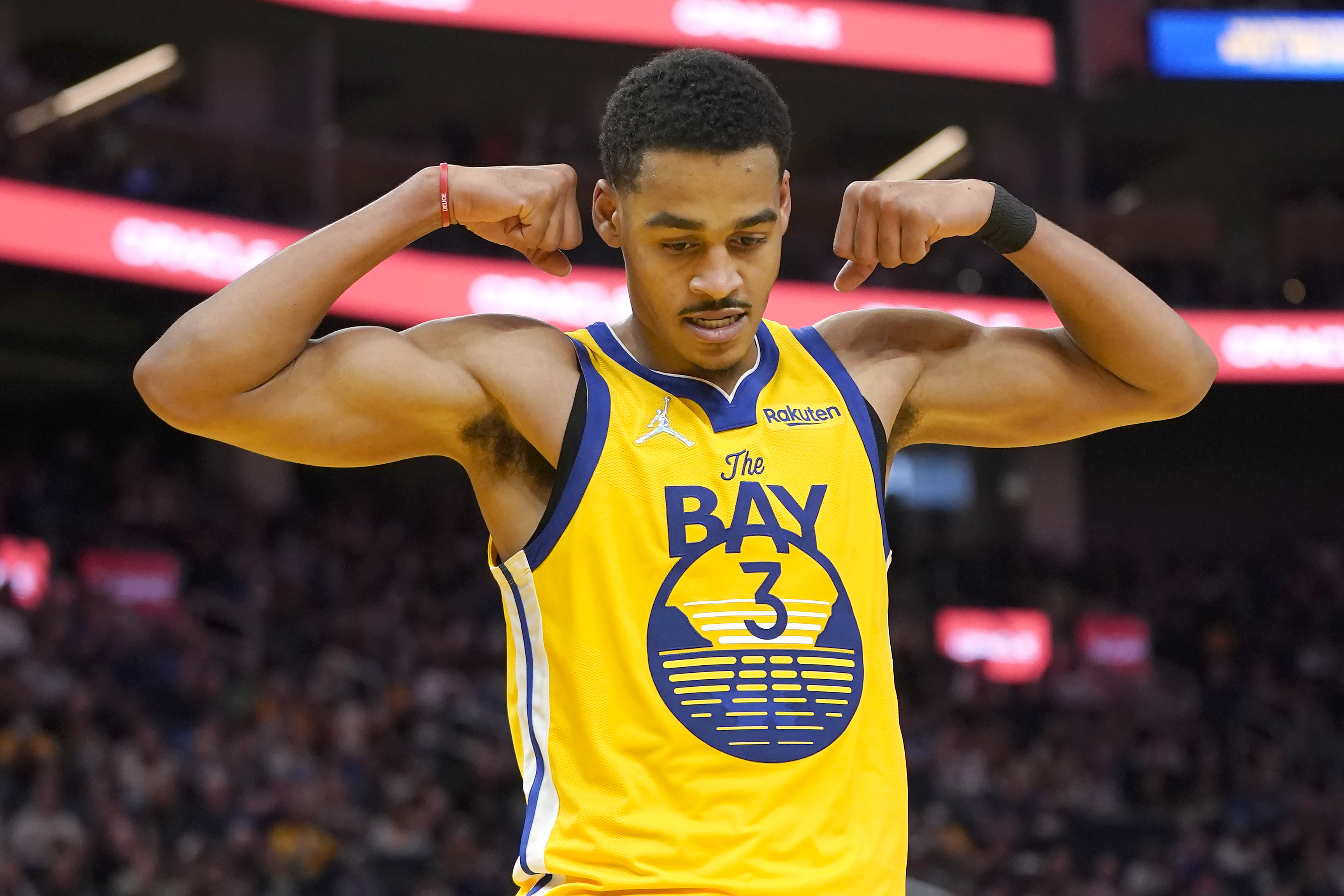 Golden State Warriors guard Jordan Poole (3) reacts after teammate Chris Chiozza scored against the Toronto Raptors during the second half of an NBA basketball game in San Francisco, Sunday, Nov. 21, 2021. (AP Photo/Jeff Chiu)