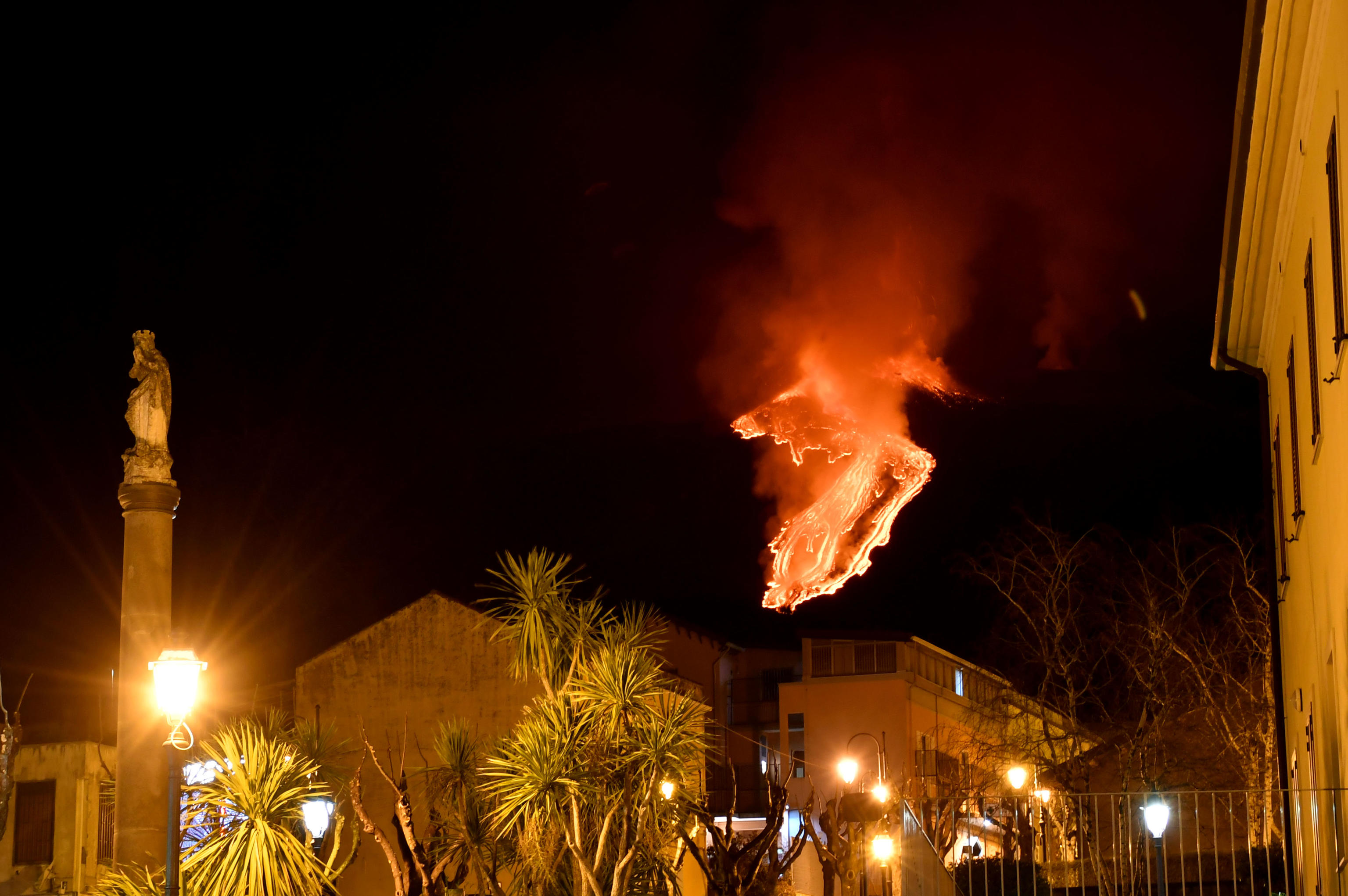 epaselect epa09027262 A lava stream runs down the slopes as Mount Etna volcano erupts, as seen from Milo, near Catania, Sicily, Italy, 21 February 2021.  EPA-EFE/Orietta Scardino