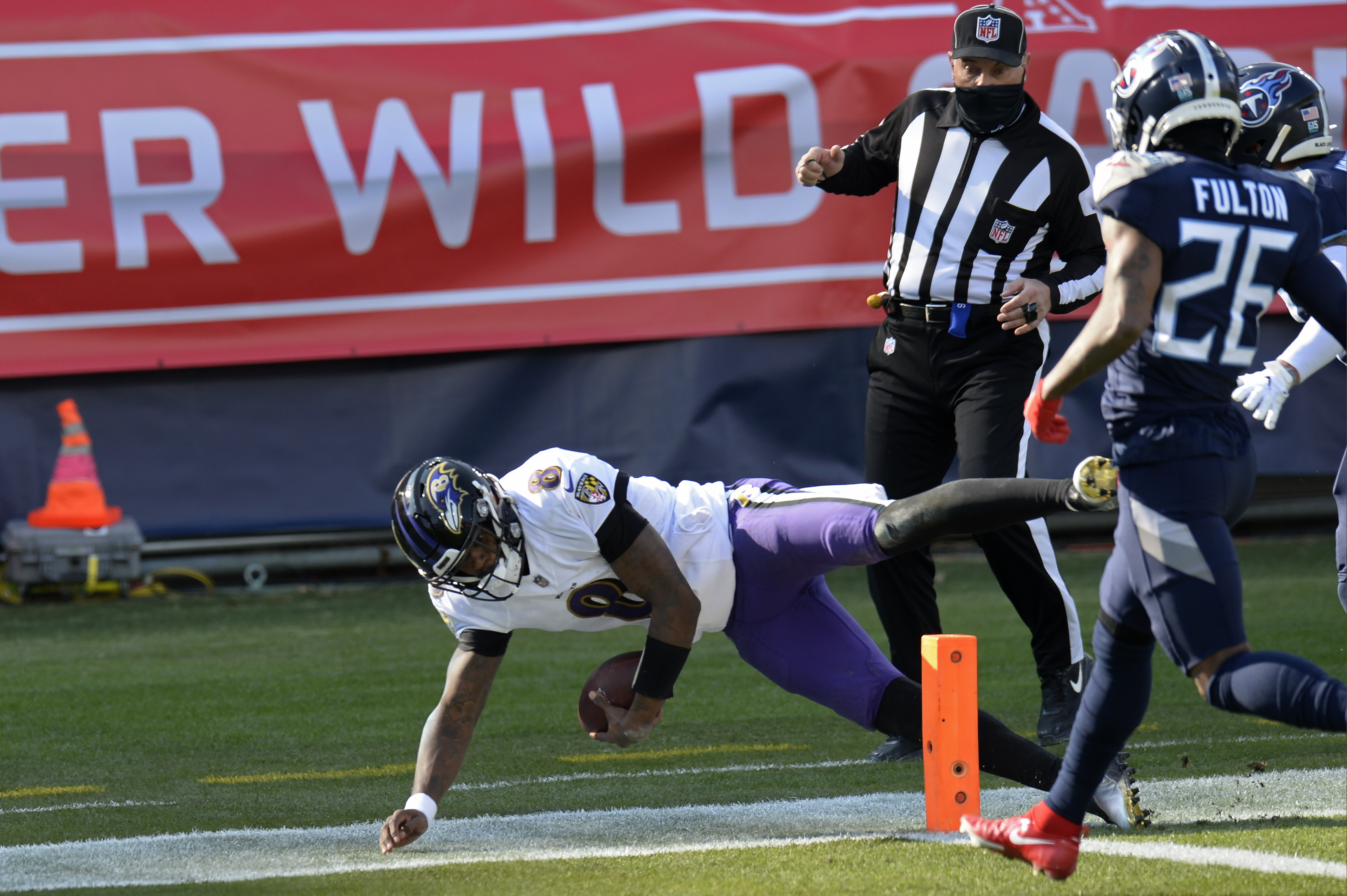 Baltimore Ravens quarterback Lamar Jackson (8) scores a touchdown on a 48-yard run against the Tennessee Titans in the first half of an NFL wild-card playoff football game Sunday, Jan. 10, 2021, in Nashville, Tenn. (AP Photo/Mark Zaleski)
