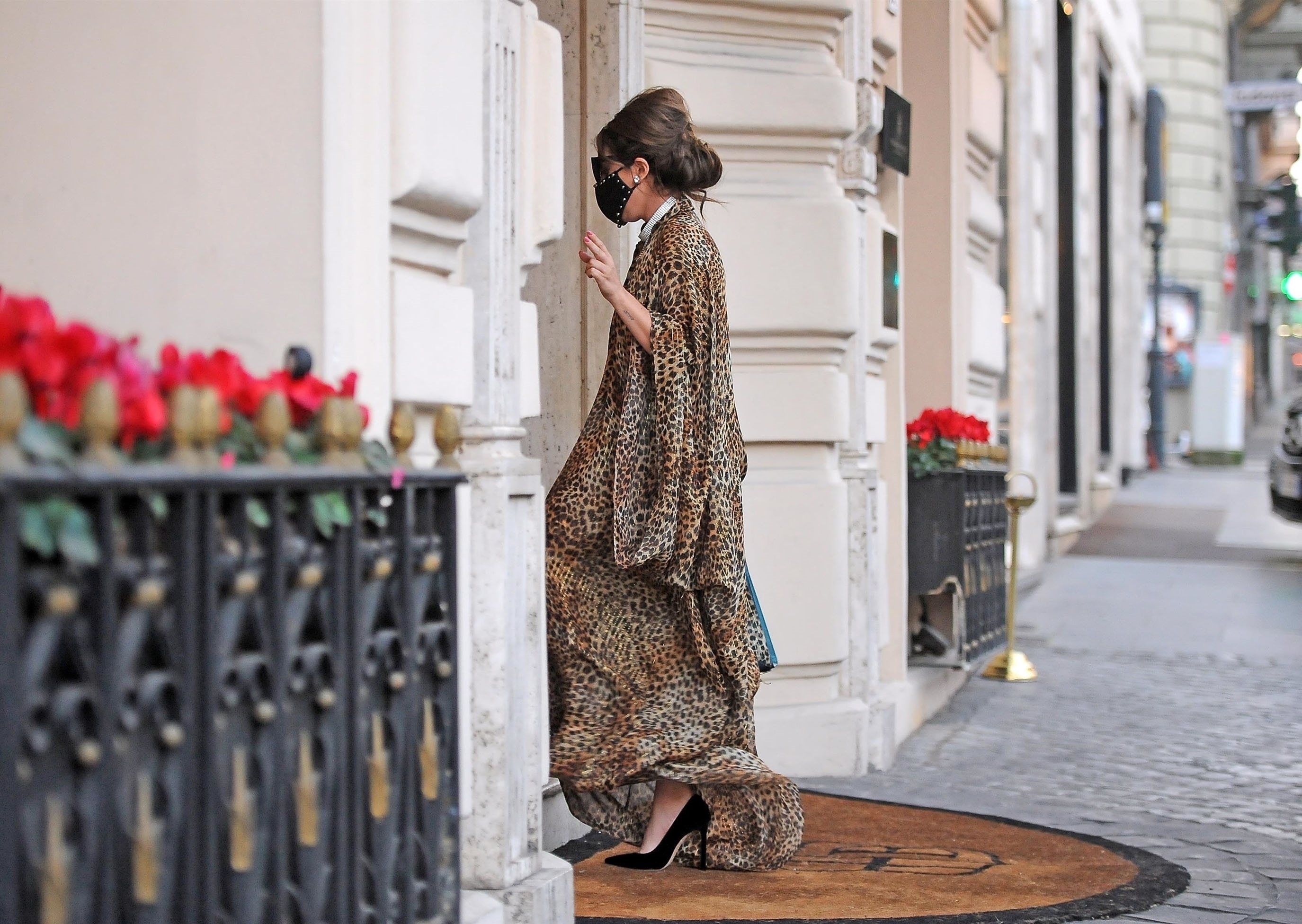 American singer Lady Gaga looks every inch a glamourous pop star wearing her animal printed kaftan and black studded face mask out in Rome.