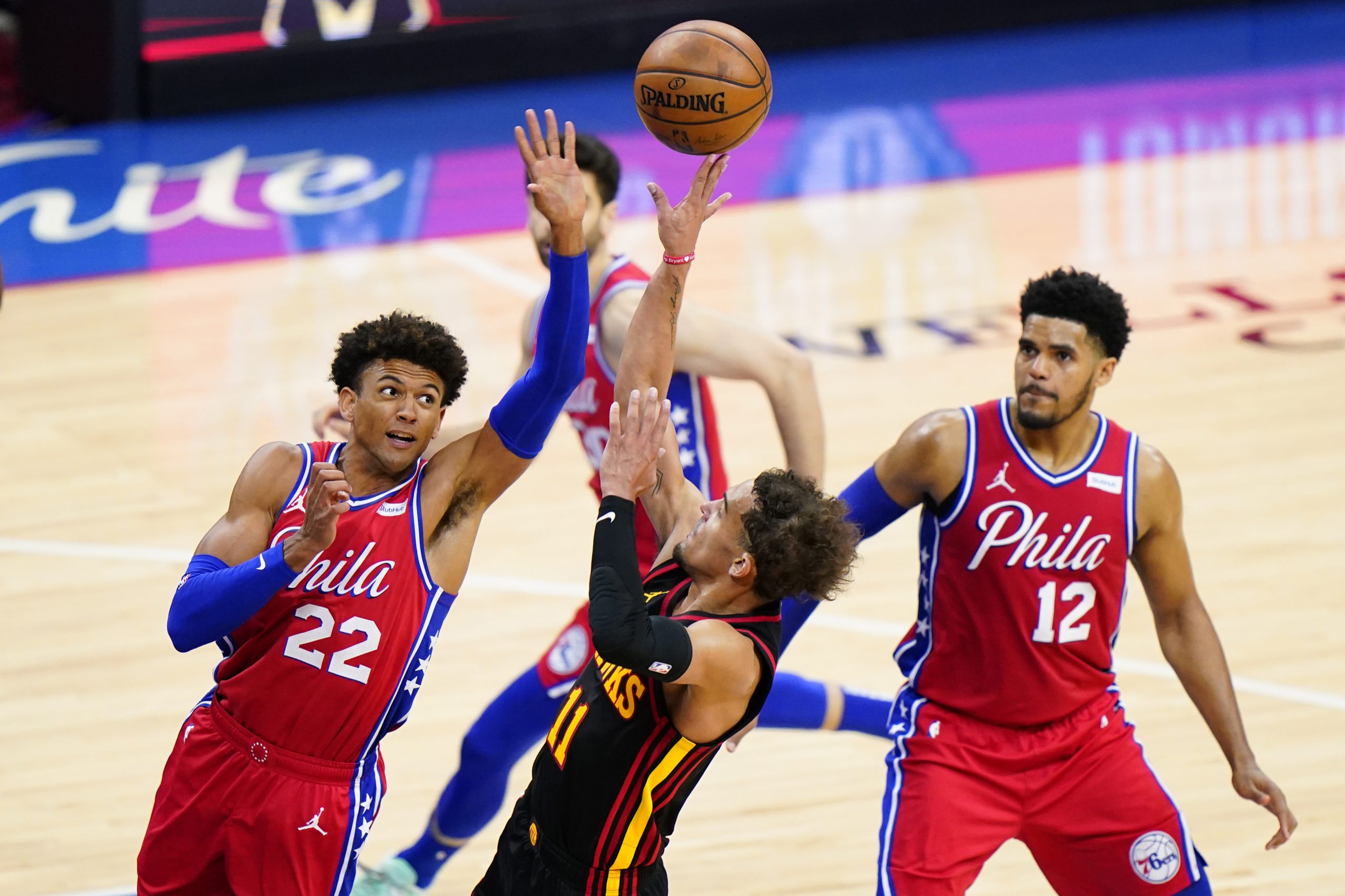Atlanta Hawks' Trae Young center, goes up for a shot against Philadelphia 76ers' Matisse Thybulle, left, during the second half of Game 1 of a second-round NBA basketball playoff series, Sunday, June 6, 2021, in Philadelphia. (AP Photo/Matt Slocum)