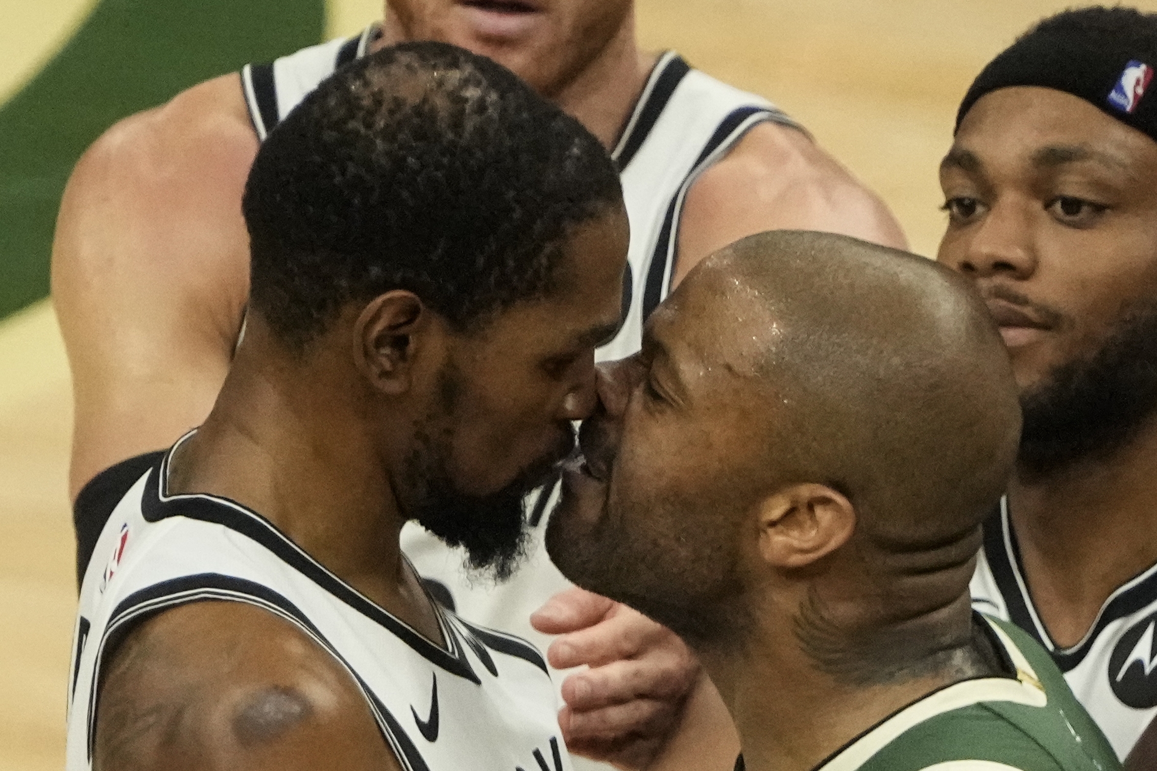 Milwaukee Bucks' P.J. Tucker and Brooklyn Nets' Kevin Durant have words during the second half of Game 3 of the NBA Eastern Conference basketball semifinals game Thursday, June 10, 2021, in Milwaukee. (AP Photo/Morry Gash)