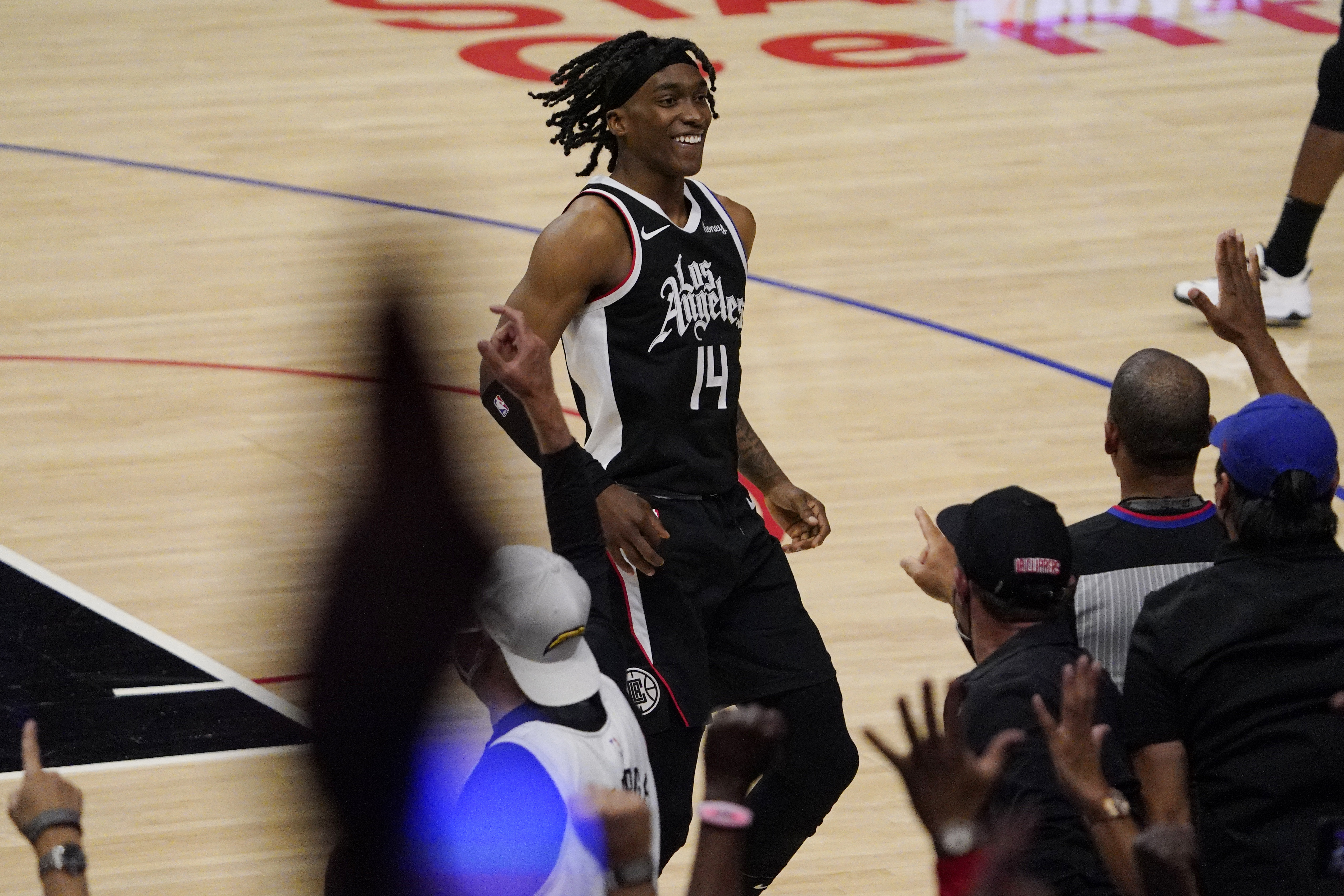 Los Angeles Clippers guard Terance Mann celebrates with fans after scoring during the second half in Game 6 of a second-round NBA basketball playoff series against the Utah Jazz Friday, June 18, 2021, in Los Angeles. (AP Photo/Mark J. Terrill)