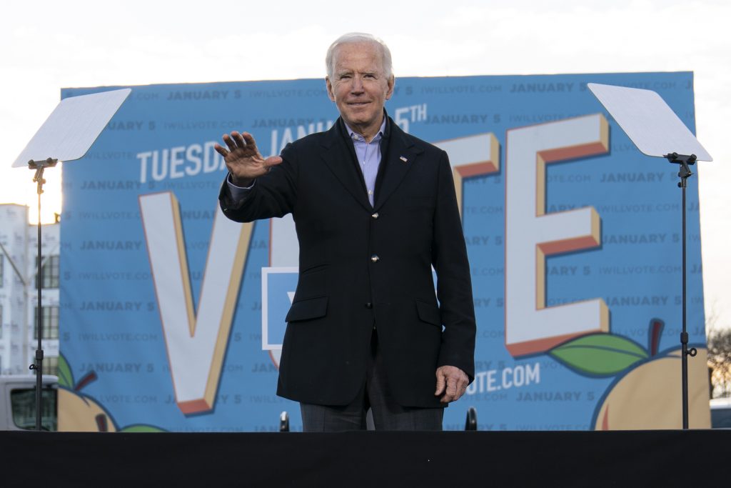 President-elect Joe Biden waves from the stage as he campaigns for for Georgia Democratic candidates for U.S. Senate, Rev. Raphael Warnock and Jon Ossoff in Atlanta, Monday, Jan. 4, 2021. (AP Photo/Carolyn Kaster)