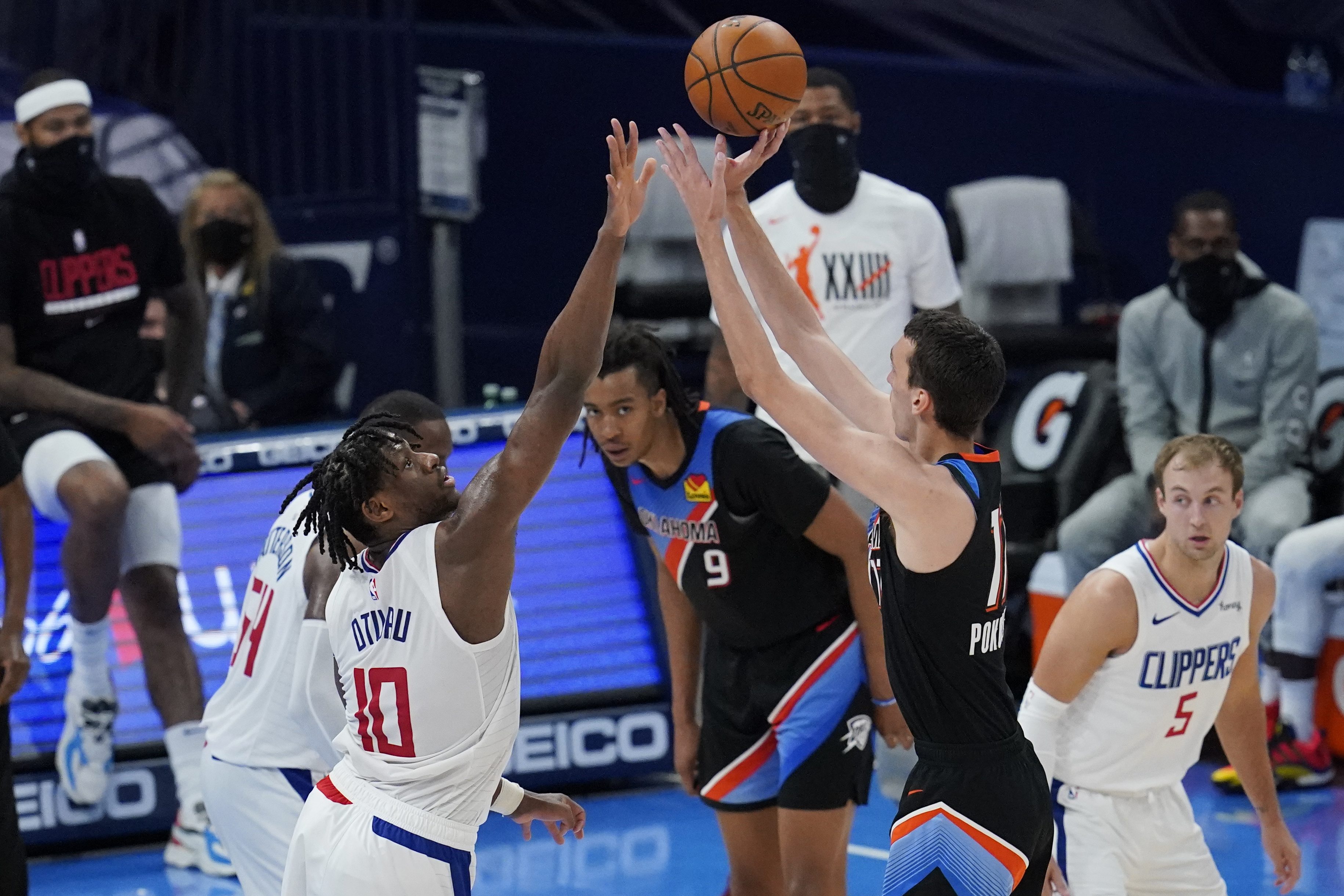 Oklahoma City Thunder forward Aleksej Pokusevski (17) shoots over Los Angeles Clippers center Daniel Oturu (10) in the second half of an NBA basketball game Sunday, May 16, 2021, in Oklahoma City. (AP Photo/Sue Ogrocki)