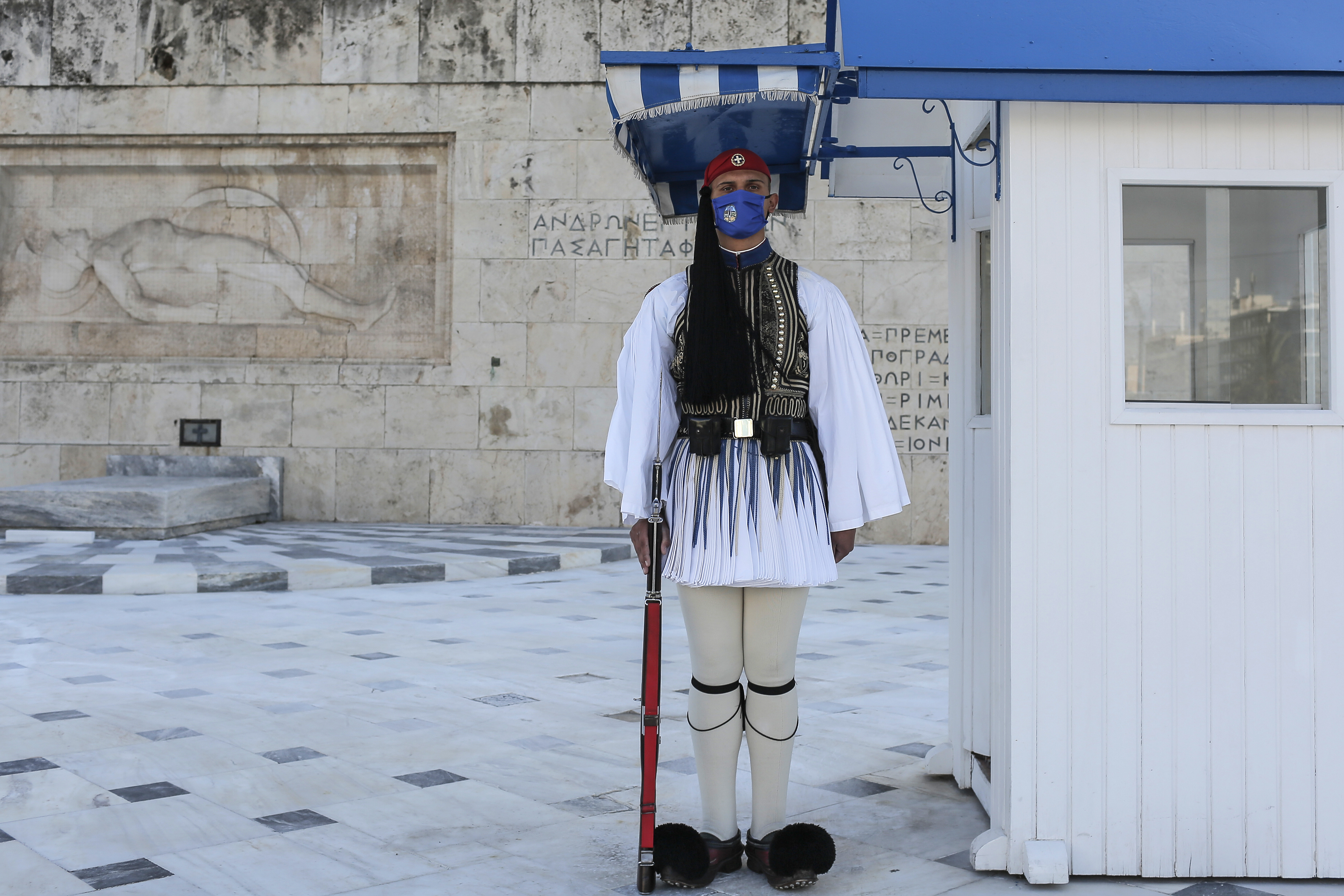 Greek Presidential Guards wearing protective face masks perform their duties