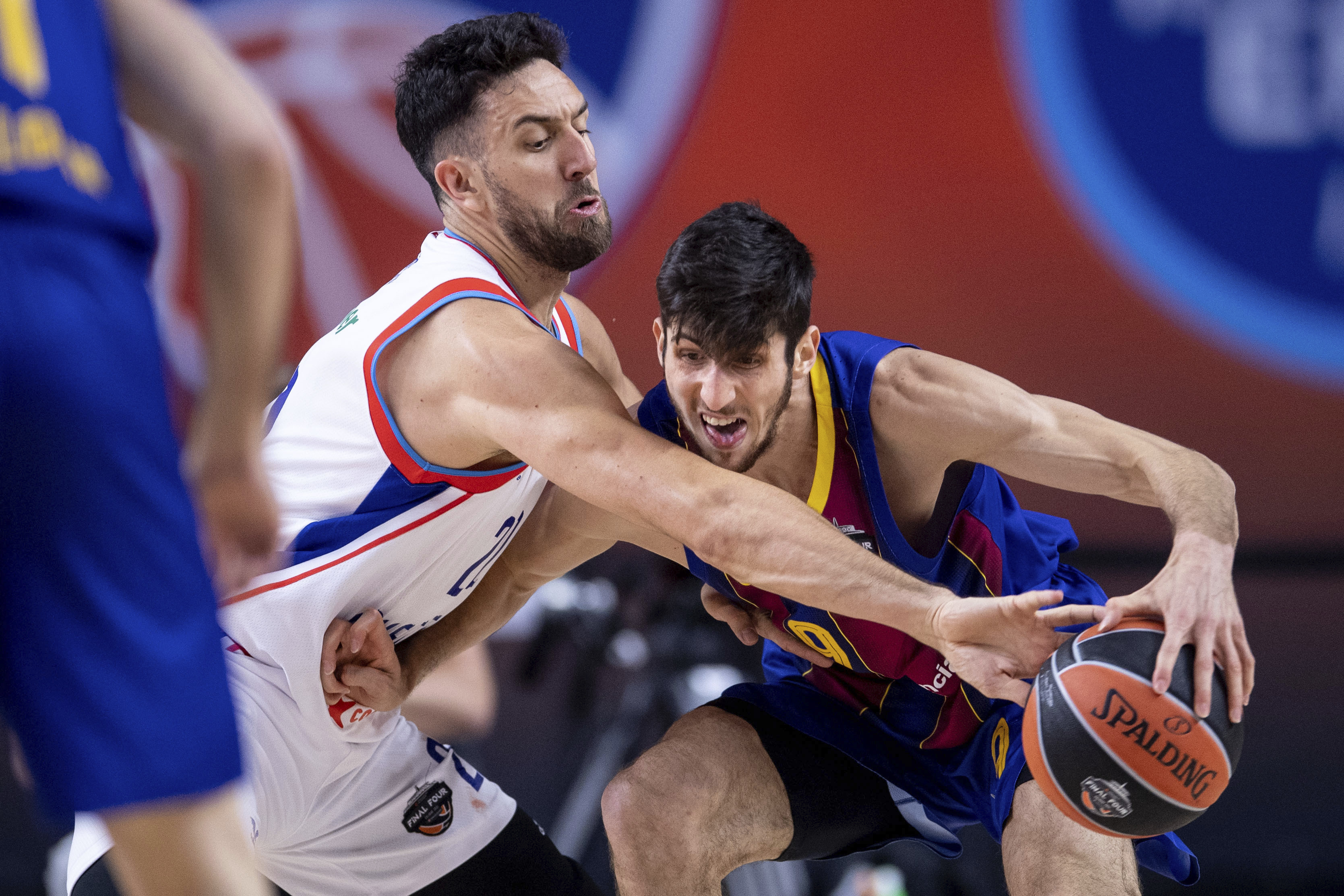 Istanbul's Vasilije Micic, left, and Barcelona's Leandro Bolmaro in action during their Euroleague final four final basketball match in Cologne, Germany, Sunday May 30, 2021. (Marius Becker/dpa via AP)