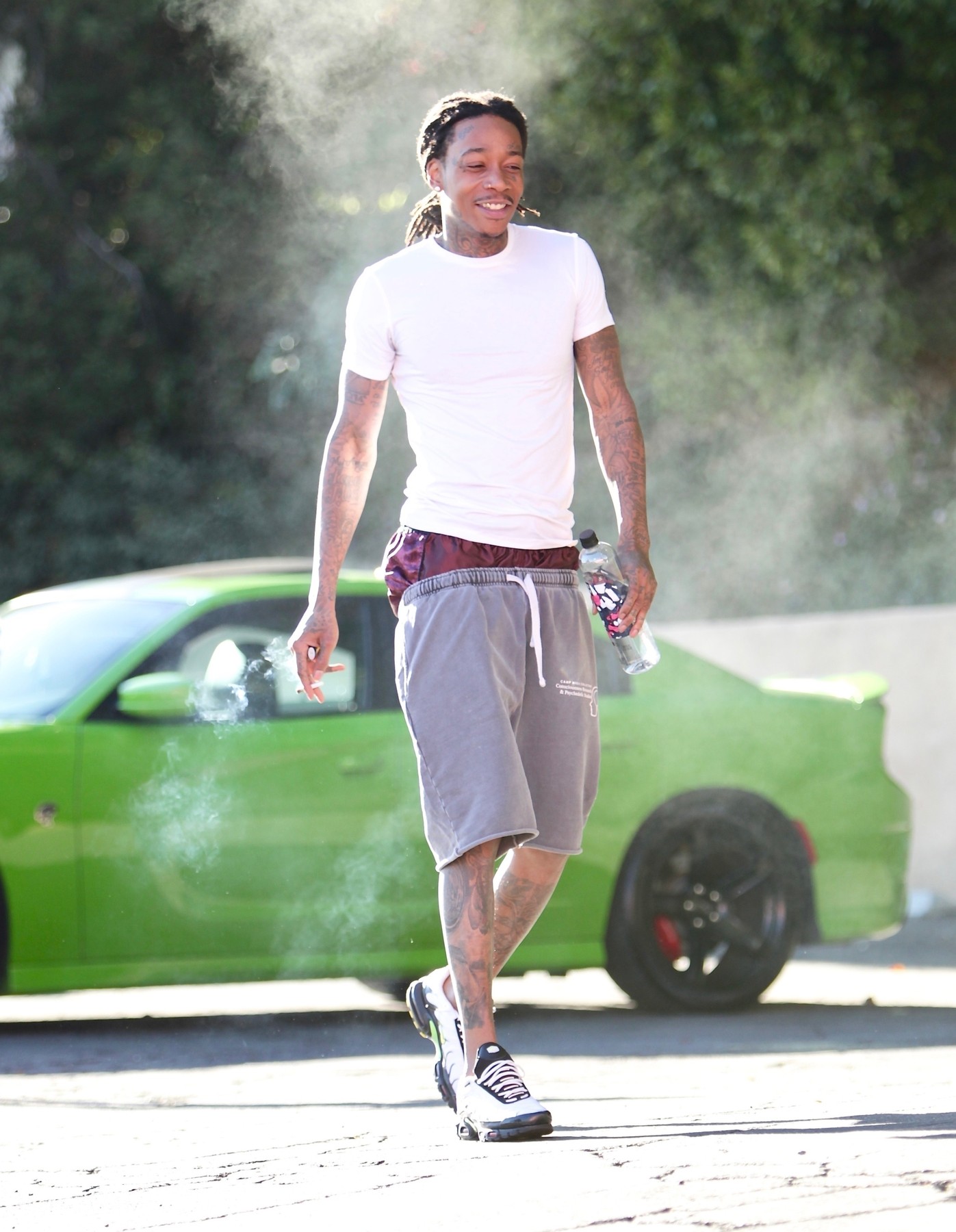 *EXCLUSIVE* Rapper Wiz Khalifa takes a few hits from his blunt before heading into a private gym