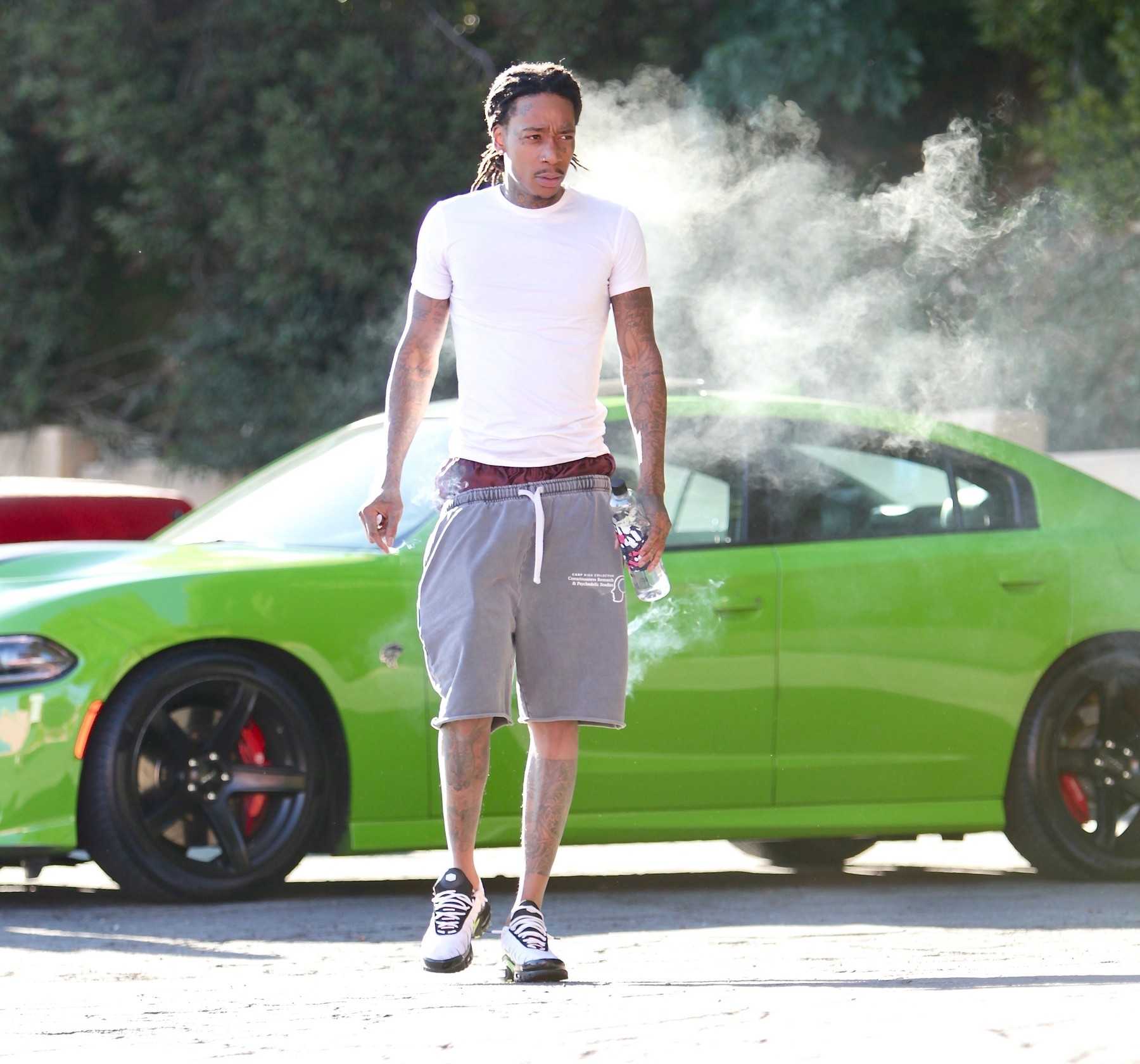*EXCLUSIVE* Rapper Wiz Khalifa takes a few hits from his blunt before heading into a private gym