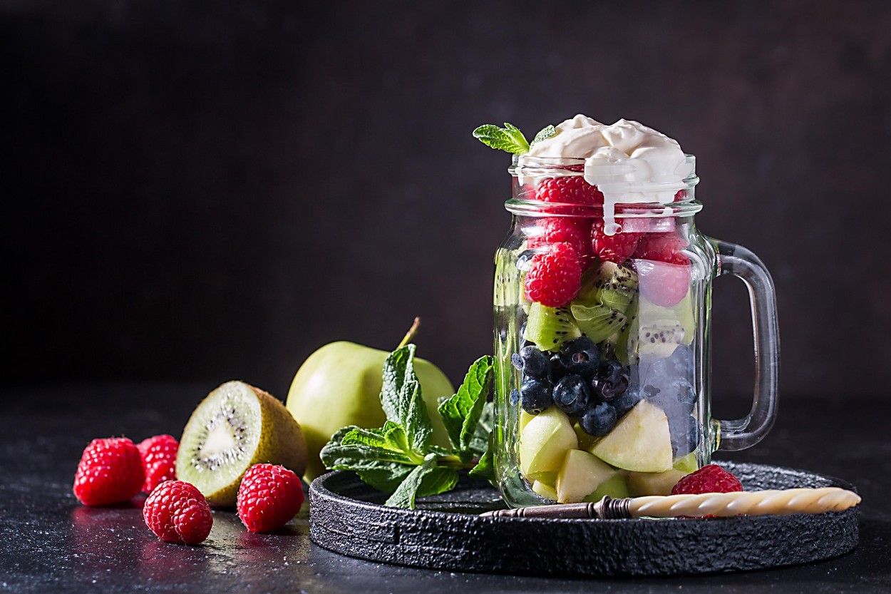 Colorful fruit salad with cream in a jar on black background,Image: 342043096, License: Royalty-free, Restrictions: , Model Release: no, Credit line: Petr Goskov / Alamy / Alamy / Profimedia