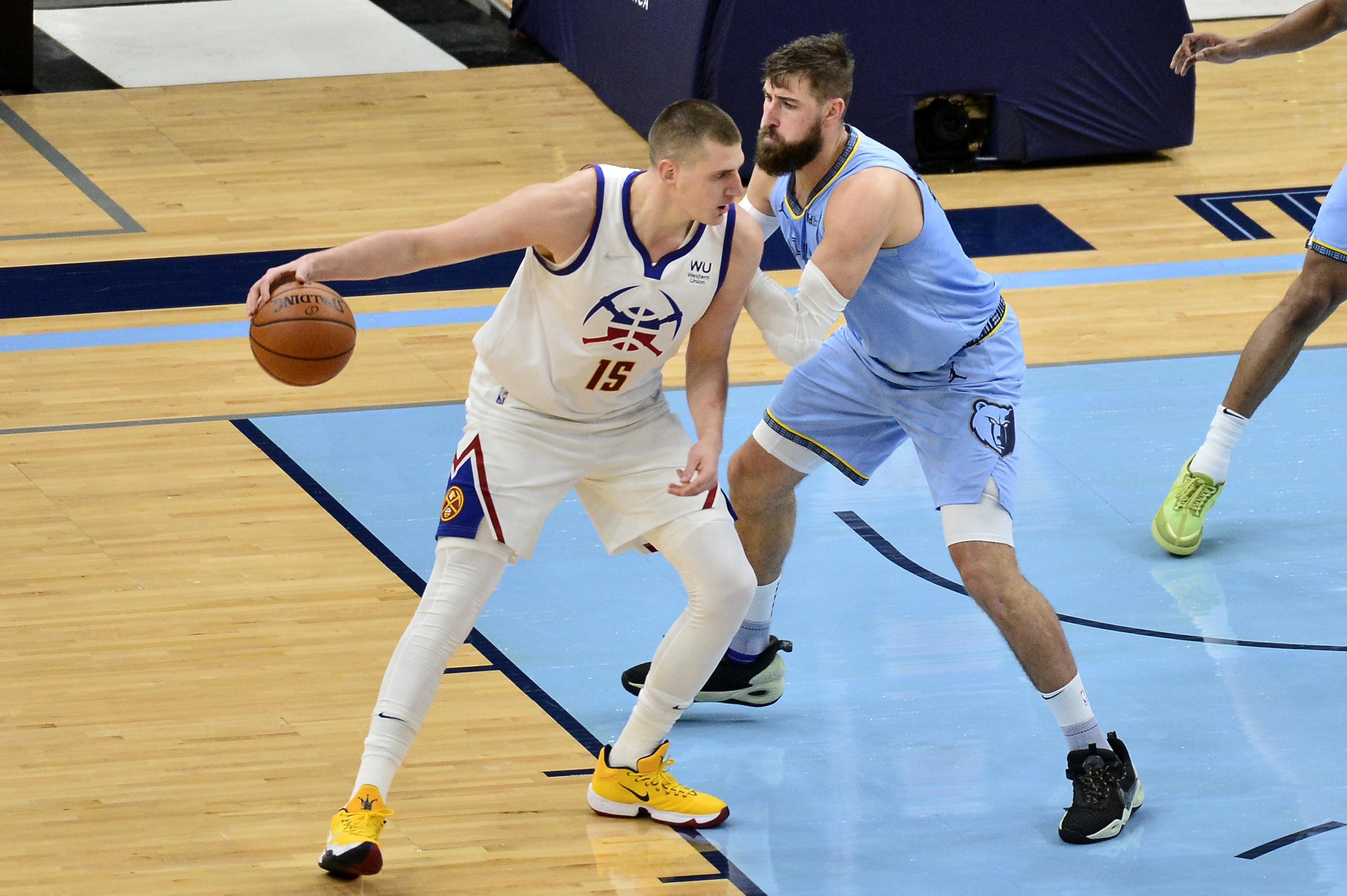 Denver Nuggets center Nikola Jokic (15) handles the ball against Memphis Grizzlies center Jonas Valanciunas in the first half of an NBA basketball game Friday, March 12, 2021, in Memphis, Tenn. (AP Photo/Brandon Dill)