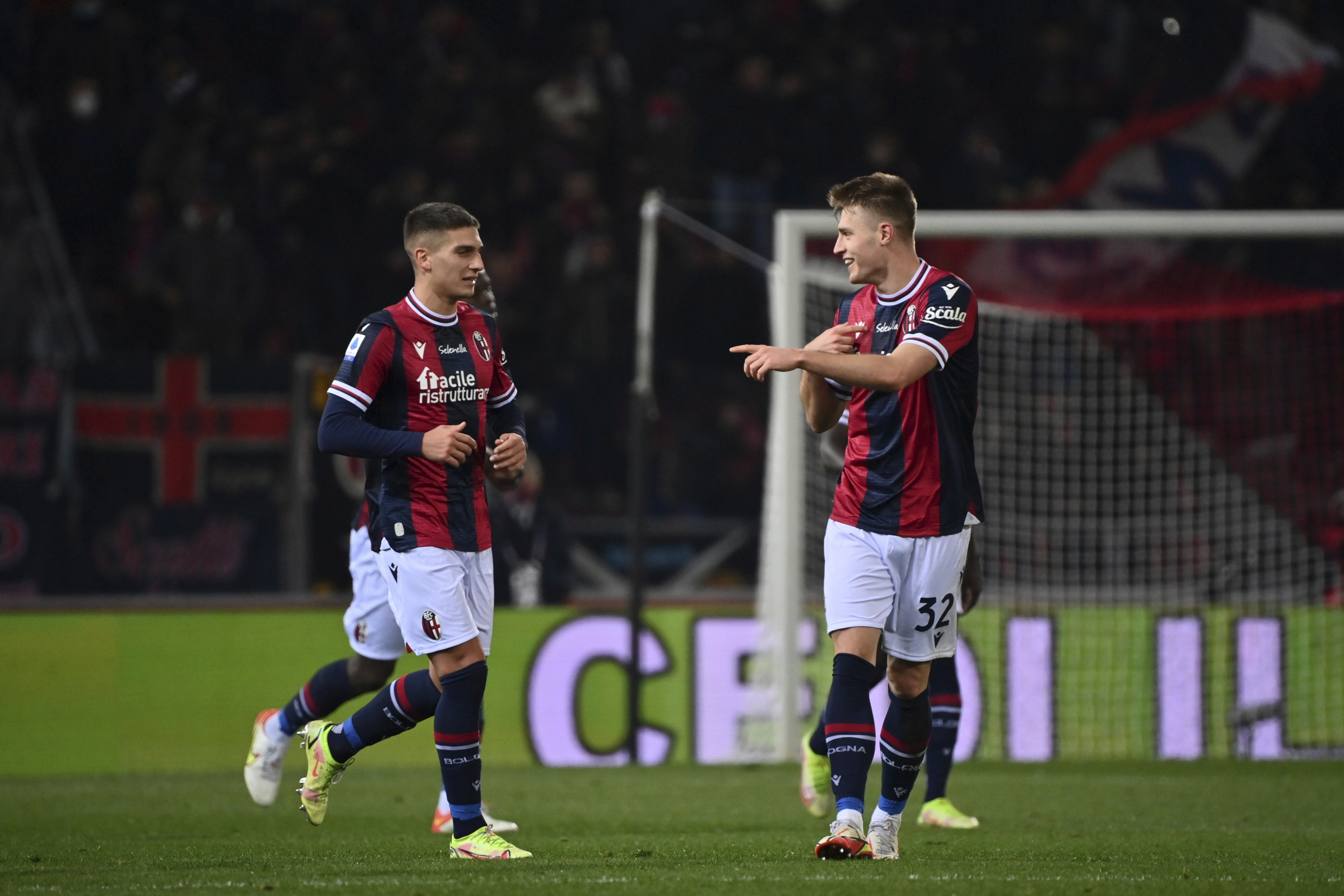 Bologna's Mattias Svanberg, right, celebrates with Nicolas Dominguez after scoring the Serie A soccer match between Bologna and Roma, at the Renato Dall'Ara stadium in Bologna, Italy, Wednesday, Dec. 1, 2021. (Massimo Paolone/LaPresse via AP)