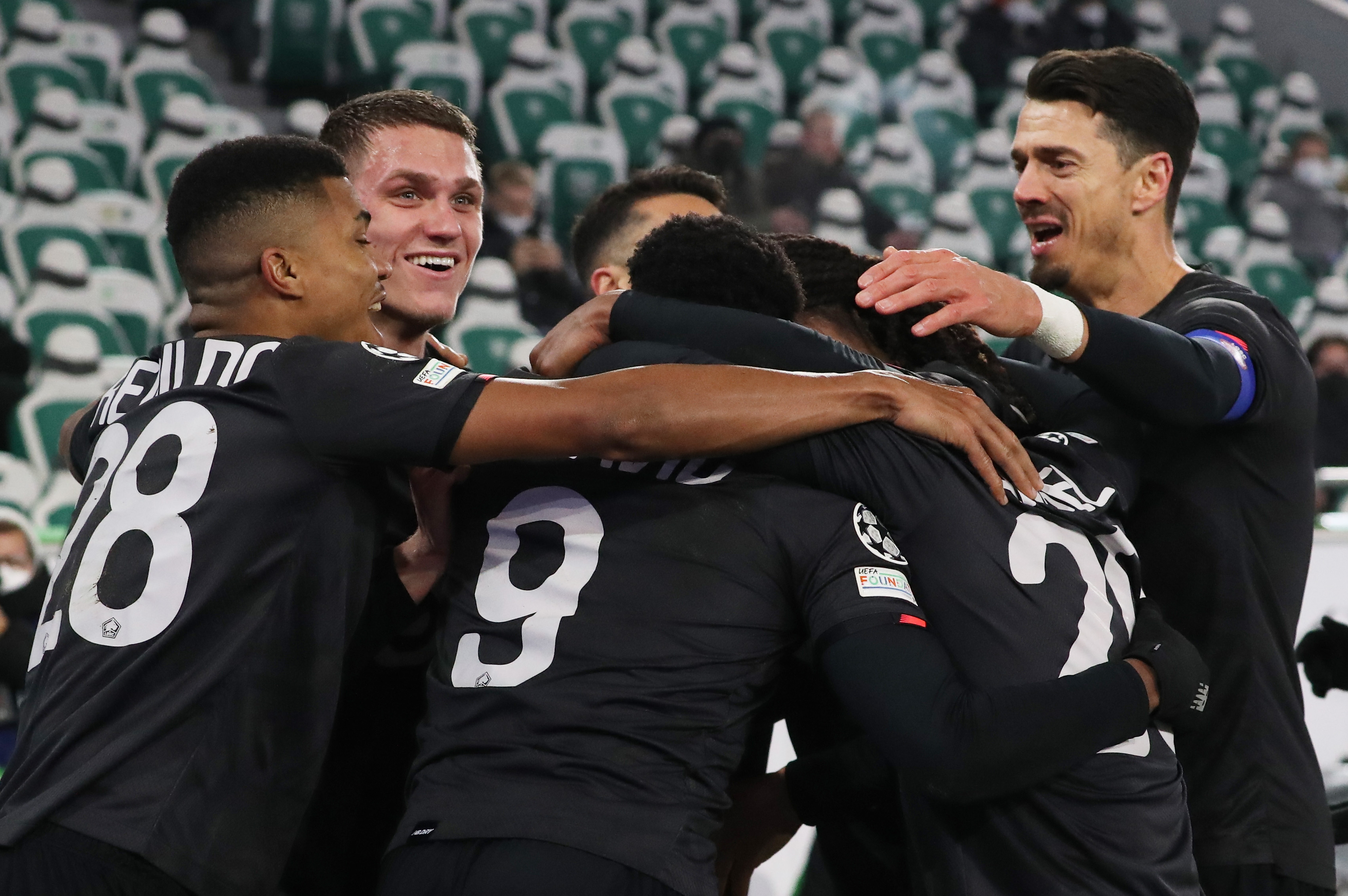 epa09630627 Lille's Jose Fonte (R) and teammates celebrate their second goal during the UEFA Champions League group G soccer match between VfL Wolfsburg and Lille OSC (LOSC) in Wolfsburg, Germany, 08 December 2021.  EPA-EFE/Focke Strangmann