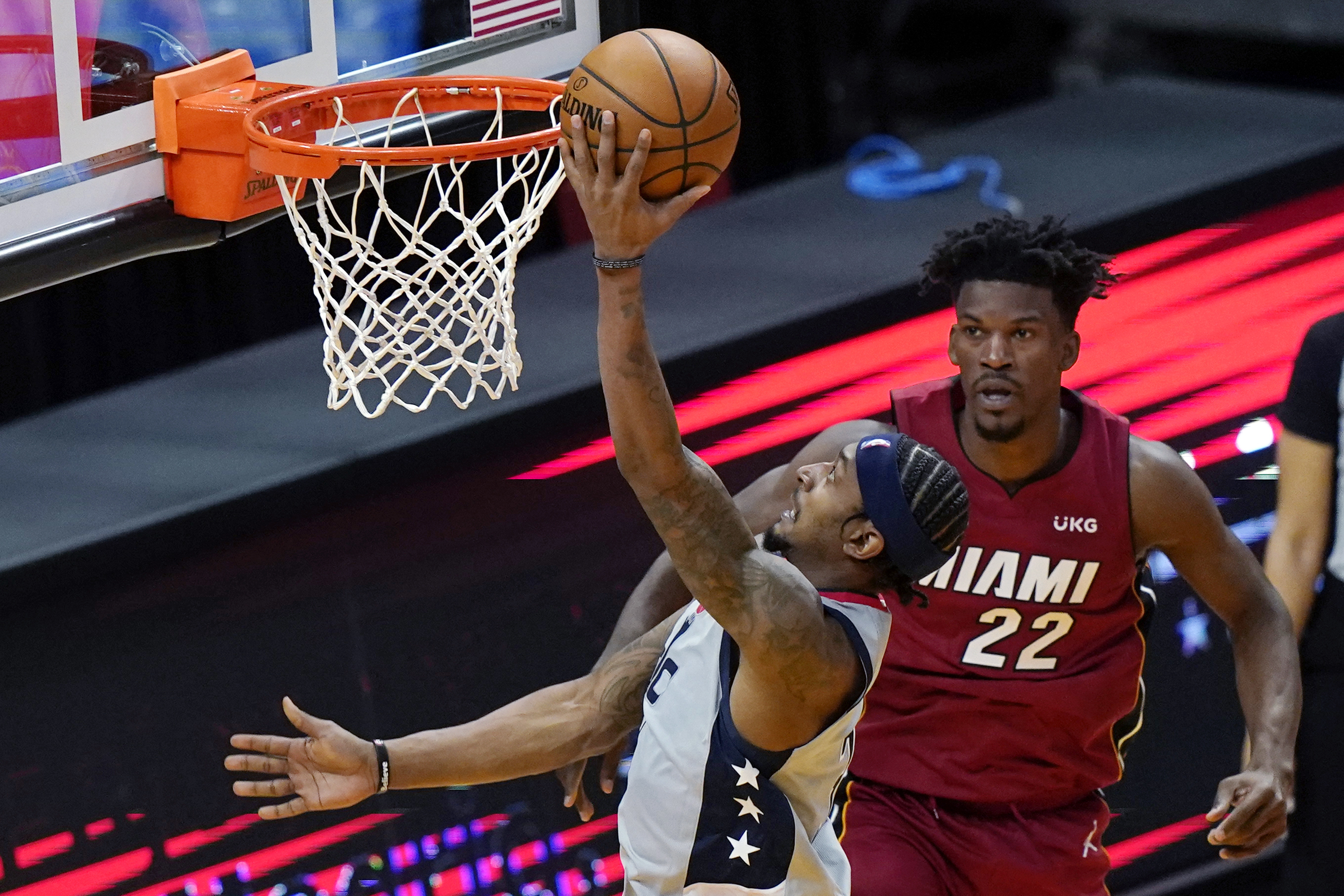 Washington Wizards guard Bradley Beal, ledt, shoots next to Miami Heat forward Jimmy Butler during the second half of an NBA basketball game Wednesday, Feb. 3, 2021, in Miami. (AP Photo/Lynne Sladky)