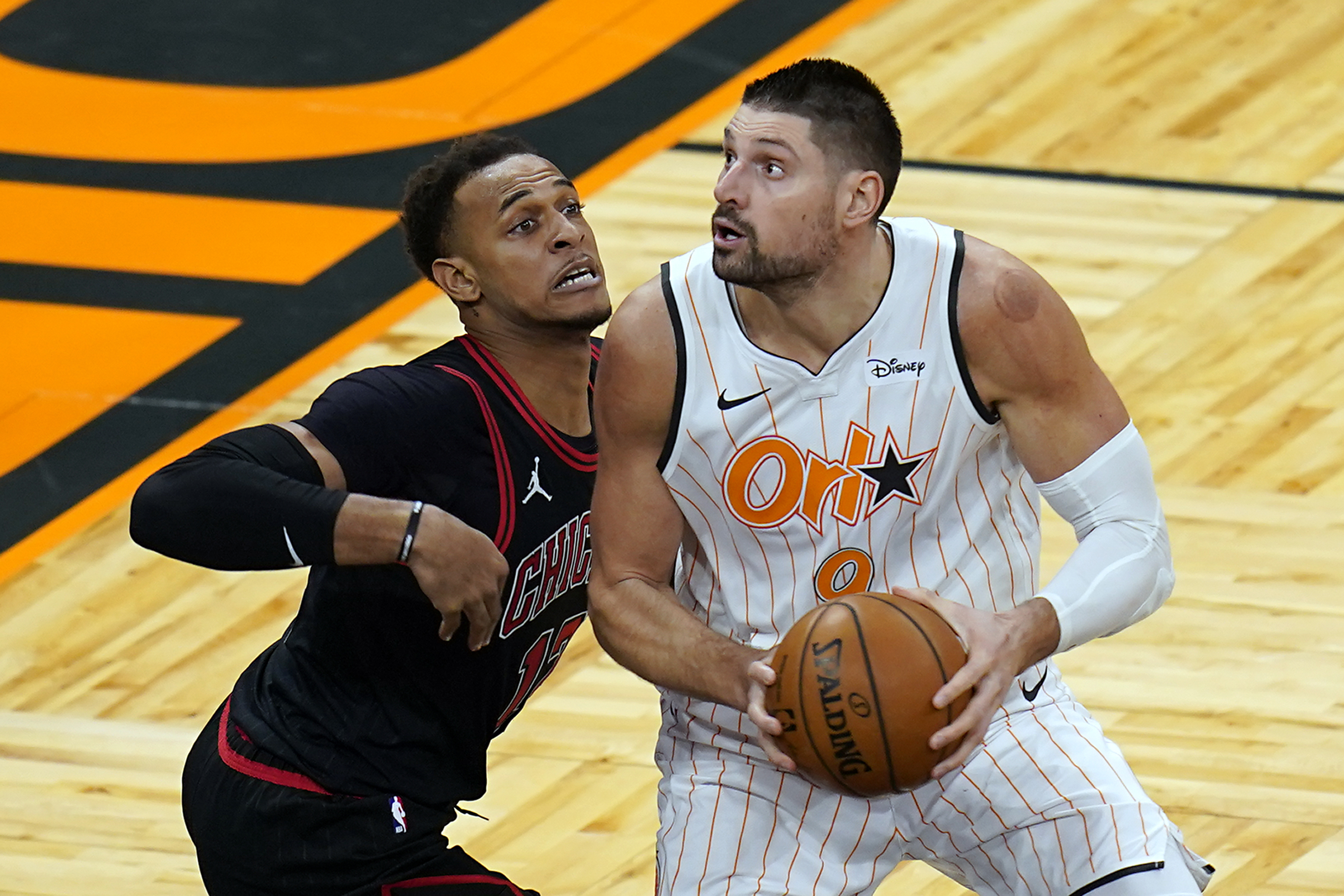 Orlando Magic center Nikola Vucevic, right, looks for a shot against Chicago Bulls center Daniel Gafford during the second half of an NBA basketball game Friday, Feb. 5, 2021, in Orlando, Fla. (AP Photo/John Raoux)