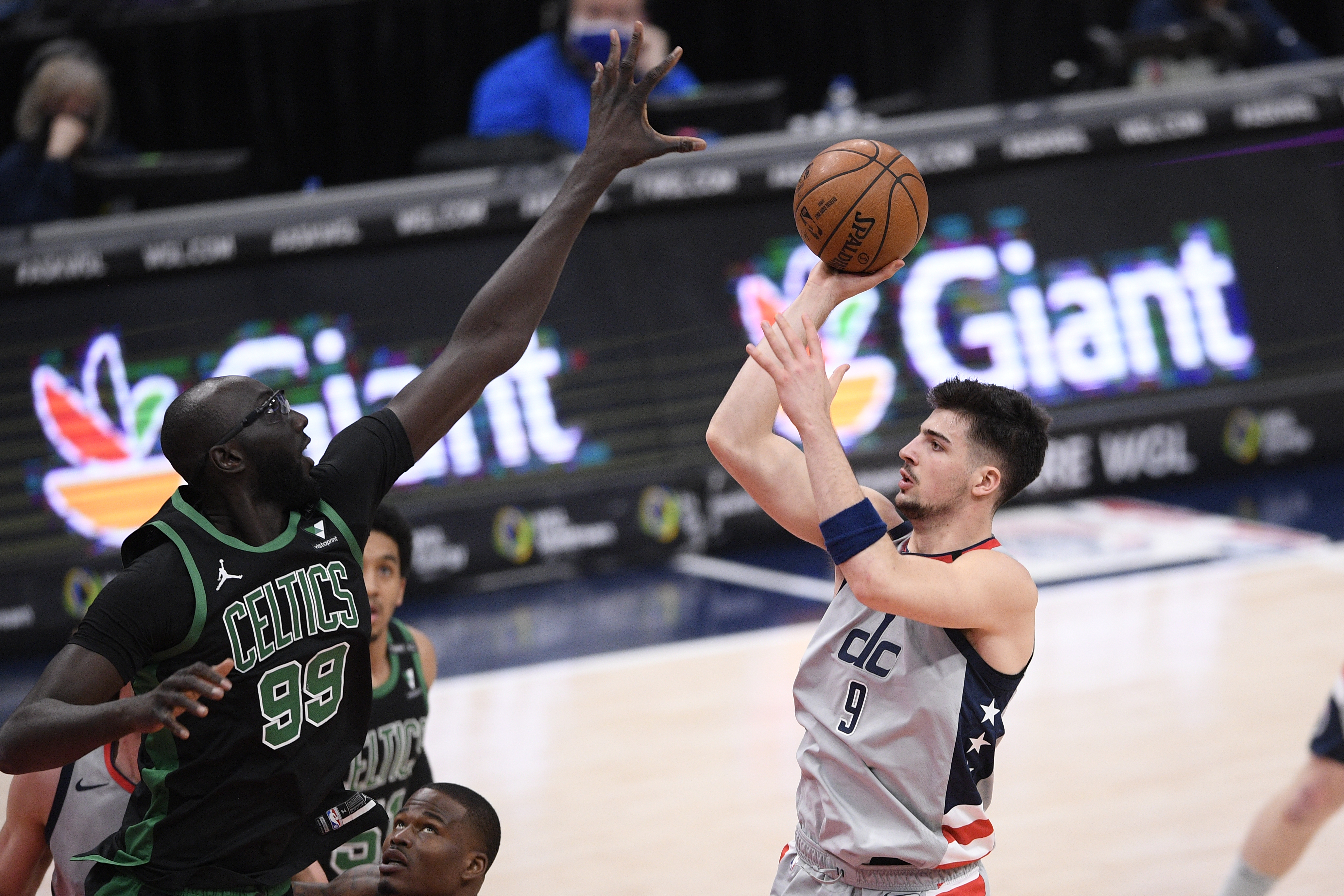 Washington Wizards forward Deni Avdija (9) shoots against Boston Celtics center Tacko Fall (99) during the second half of an NBA basketball game, Sunday, Feb. 14, 2021, in Washington. The Wizards won 104-91. (AP Photo/Nick Wass)