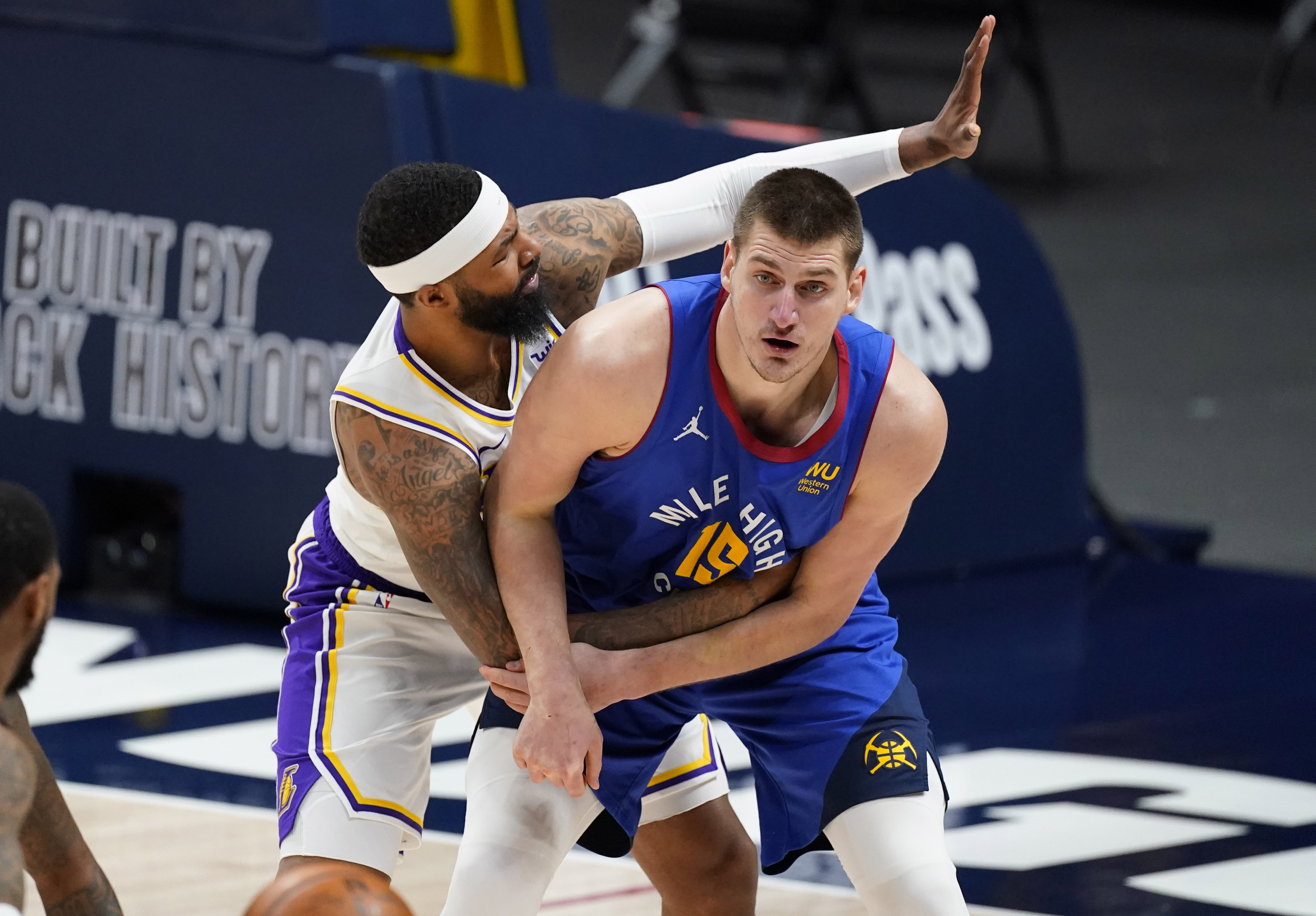 Denver Nuggets center Nikola Jokic, right, is tied up by Los Angeles Lakers forward Markieff Morris during the second half of an NBA basketball game Sunday, Feb. 14, 2021, in Denver. (AP Photo/David Zalubowski)