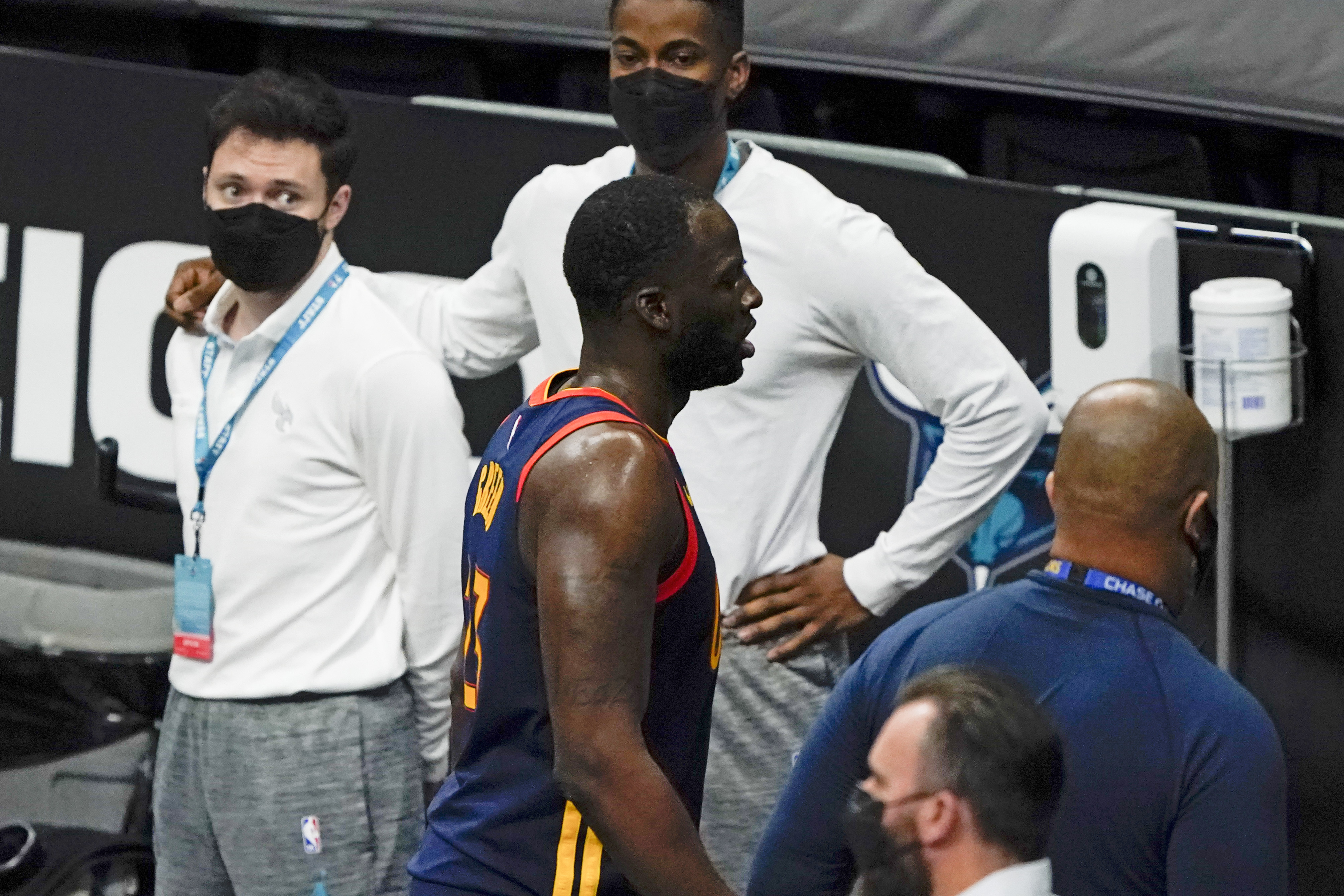 Golden State Warriors forward Draymond Green leaves the court after getting ejected from the game during the second half of an NBA basketball game against the Charlotte Hornets on Saturday, Feb. 20, 2021, in Charlotte, N.C. (AP Photo/Chris Carlson)