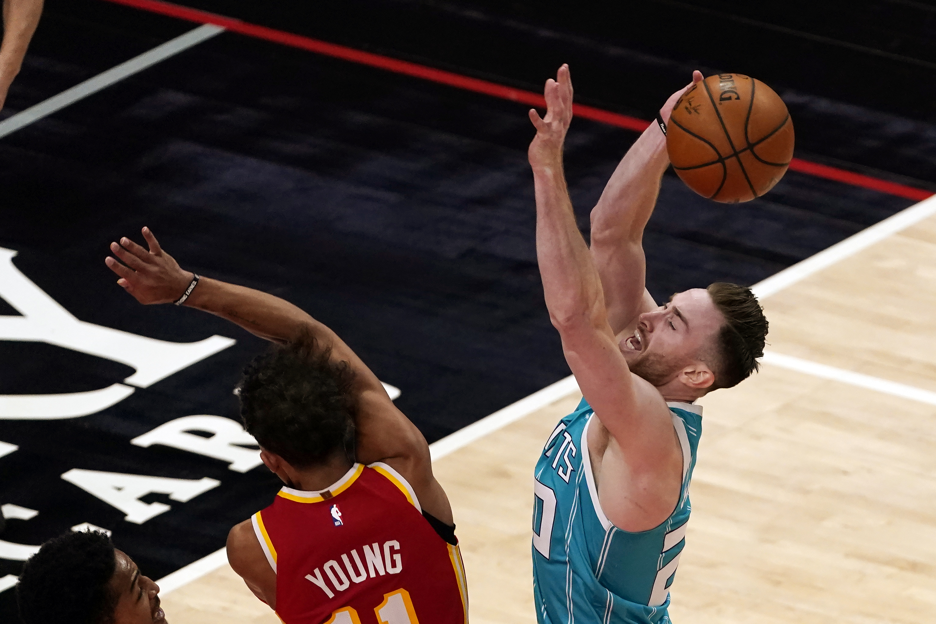 Charlotte Hornets forward Gordon Hayward (20) is fouled by Atlanta Hawks guard Trae Young (11) during the second half of an NBA basketball game Wednesday, Jan. 6, 2021, in Atlanta. (AP Photo/John Bazemore)