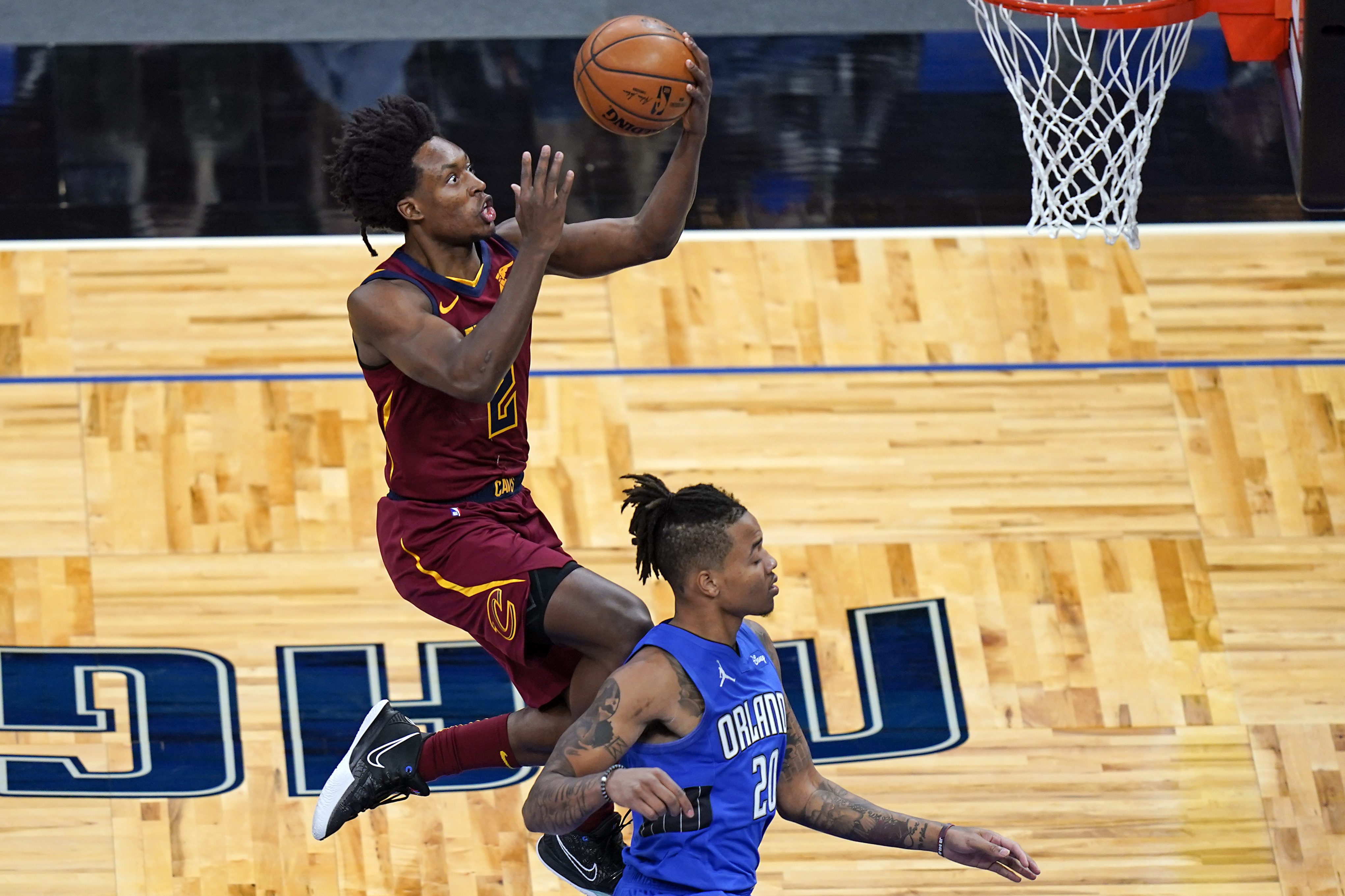 Cleveland Cavaliers guard Collin Sexton, left, goes past Orlando Magic guard Markelle Fultz for a basket during the fist half of an NBA basketball game Wednesday, Jan. 6, 2021, in Orlando, Fla. (AP Photo/John Raoux)