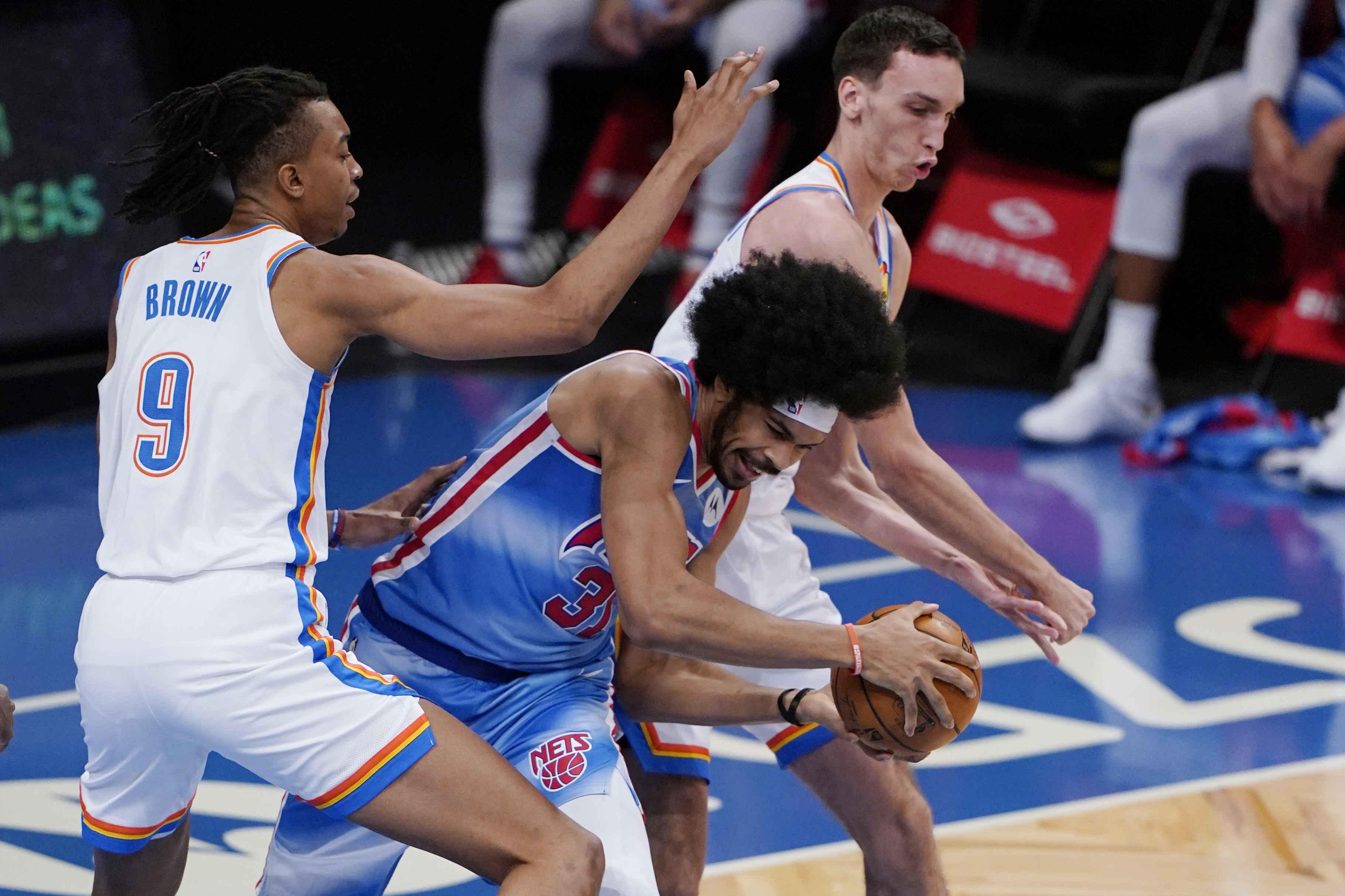 Oklahoma City Thunder center Moses Brown (9) and Thunder forward Aleksej Pokusevski (17) defend Brooklyn Nets center Jarrett Allen (31) during the second half of an NBA basketball game Sunday, Jan. 10, 2021, in New York. (AP Photo/Kathy Willens)