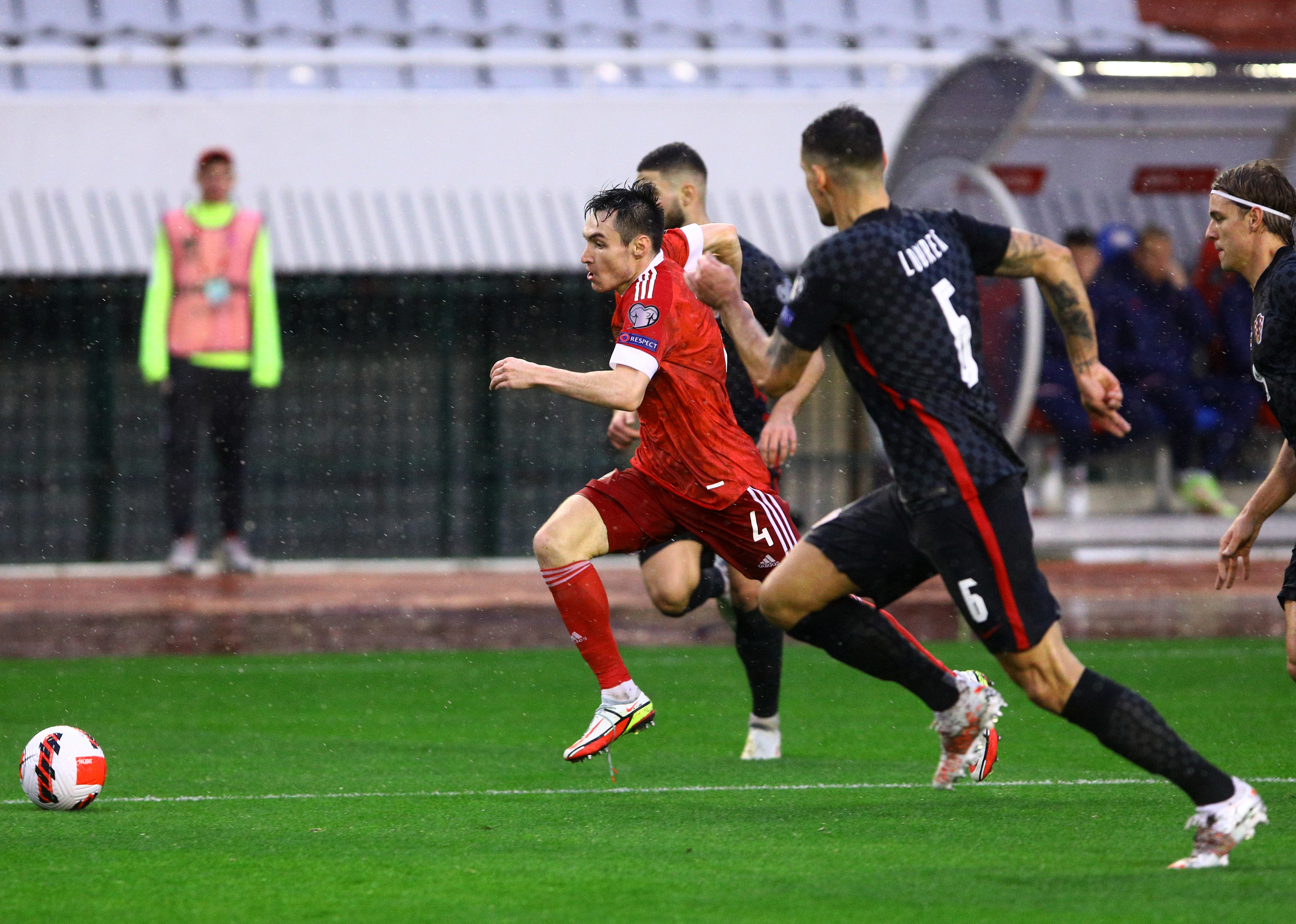 epa09581796 Vyacheslav Karavaev (L) of Russia in action against Dejan Lovren (R) of Croatia during the FIFA World Cup 2022 group H qualifying soccer match between Croatia and Russia in Split, Croatia, 14 November 2021.  EPA-EFE/STR