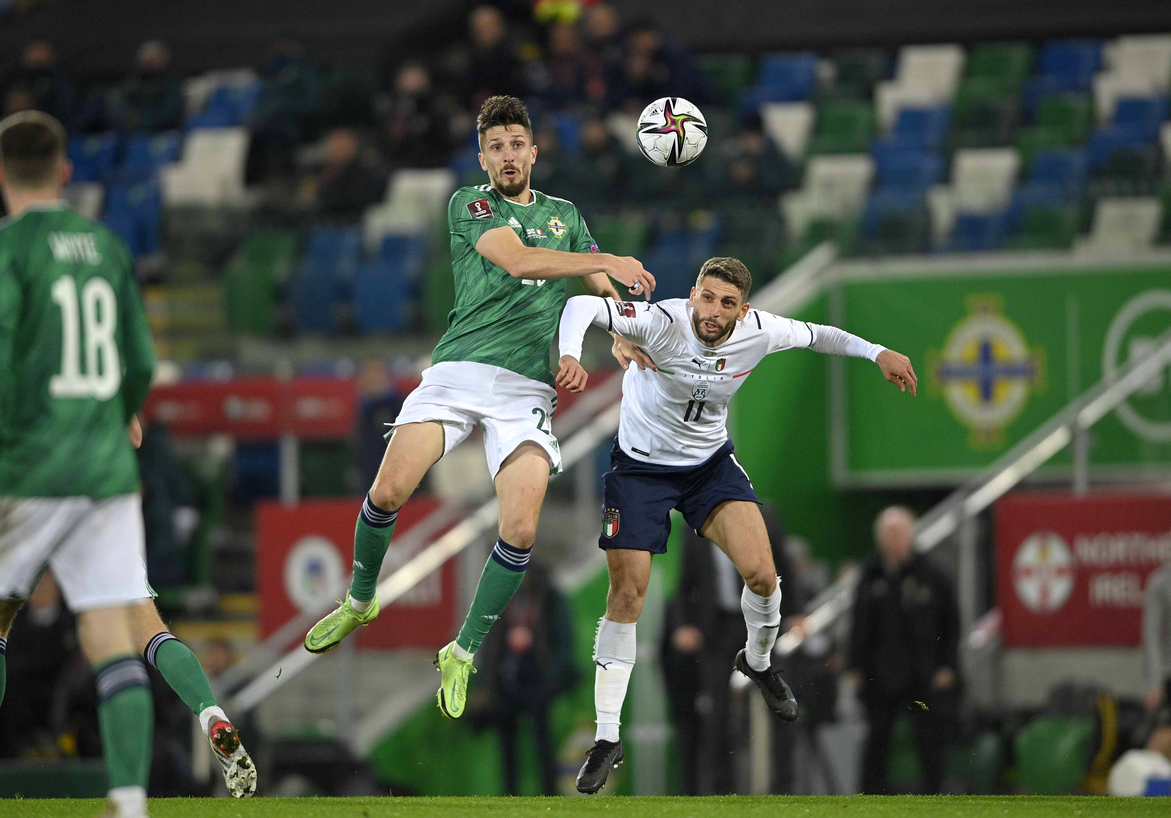 epa09584156 Italy?s Domenico Berardi (R) in action against Northern Ireland's Craig Cathcart (L) during the FIFA World Cup 2022 group C qualifying soccer match between Northern Ireland and Italy in Belfast, Britain, 15 November 2021.  EPA-EFE/MARK MARLOW
