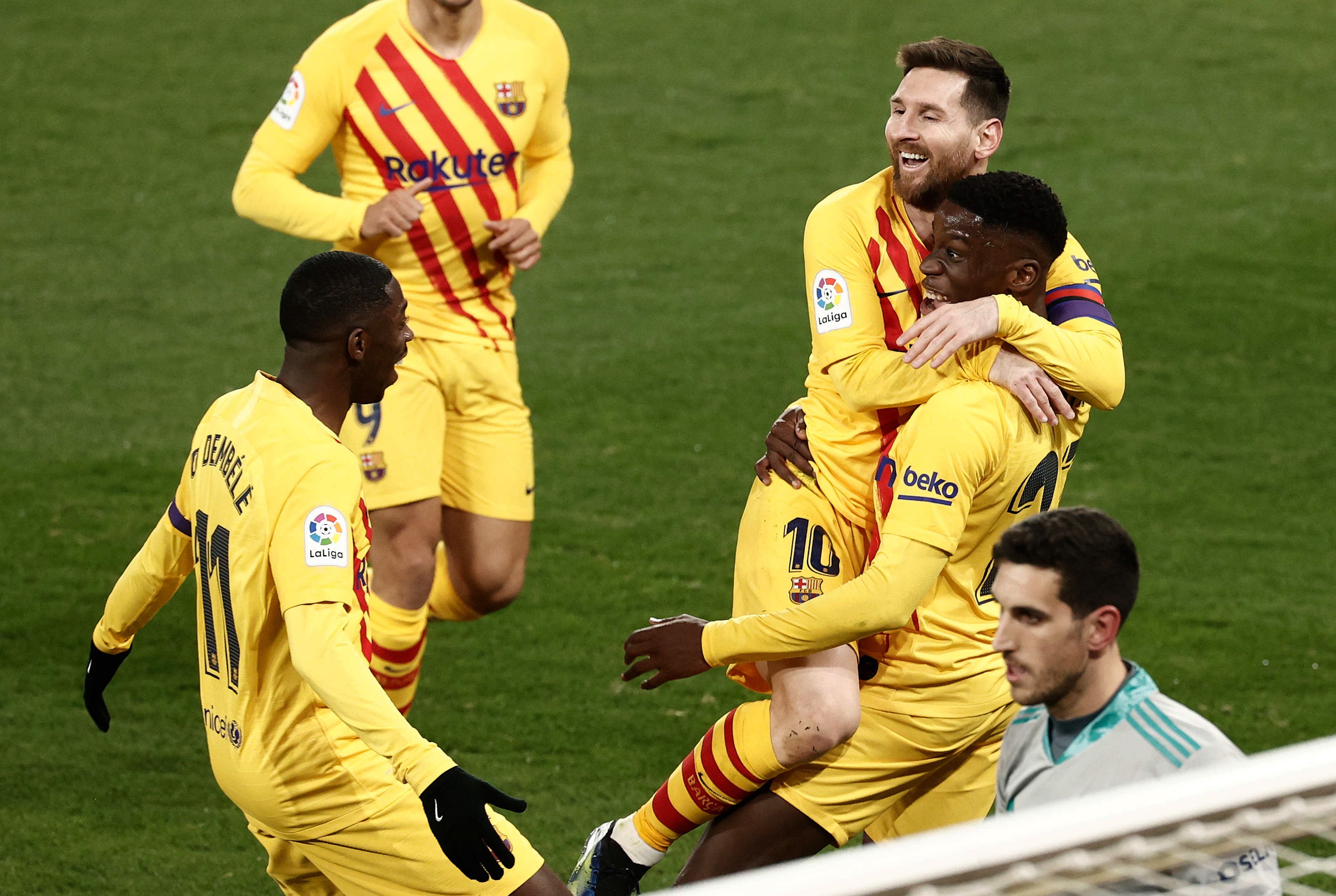 epa09058089 Barcelona's Ilaix Moriba (R) celebrates with teammates after scoring the 2-0 lead during the Spanish La Liga soccer match between CA Osasuna and FC Barcelona at El Sadar stadium in Pamplona, Spain, 06 March 2021.  EPA-EFE/Jesus Diges