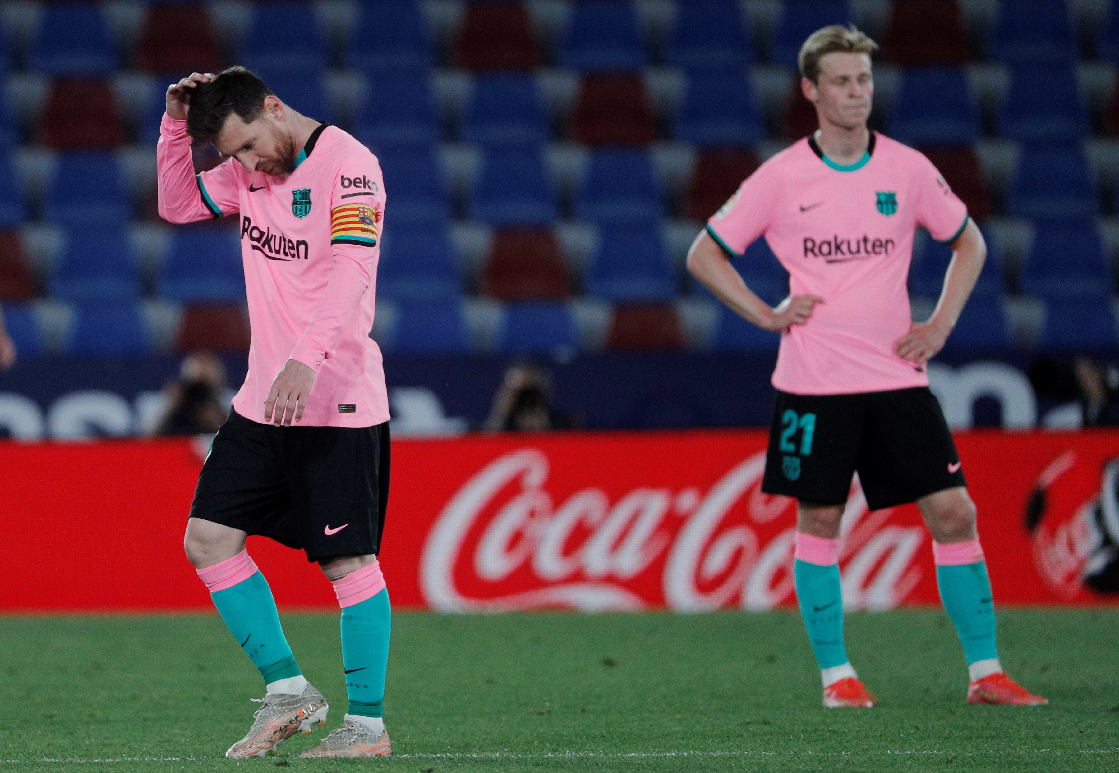 epa09192557 FC Barcelona's Leo Messi (L) and Frenkie de Jong (R) react during the Spanish LaLiga soccer match between Levante UD and FC Barcelona at Ciutat de Valencia stadium in Valencia, eastern Spain, 11 May 2021.  EPA-EFE/Juan Carlos Cardenas
