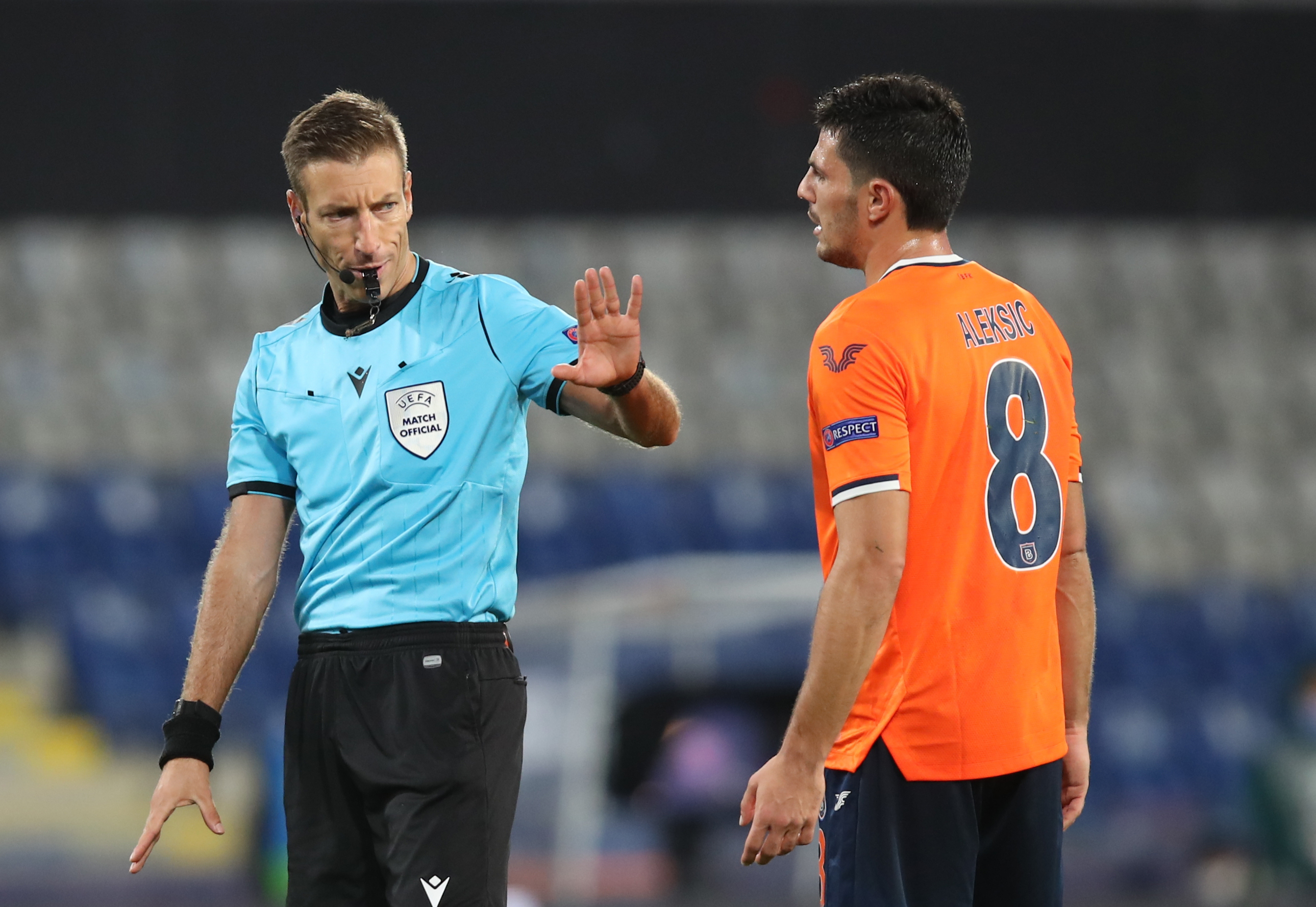 epa08798954 Italian referee Davide Massa (L) speaks to Danijel Aleksic (R) of Basaksehir during the UEFA Champions League group H soccer match between Istanbul Basaksehir and Manchester United in Istanbul, Turkey, 04 November 2020.  EPA-EFE/Tolga Bozoglu
