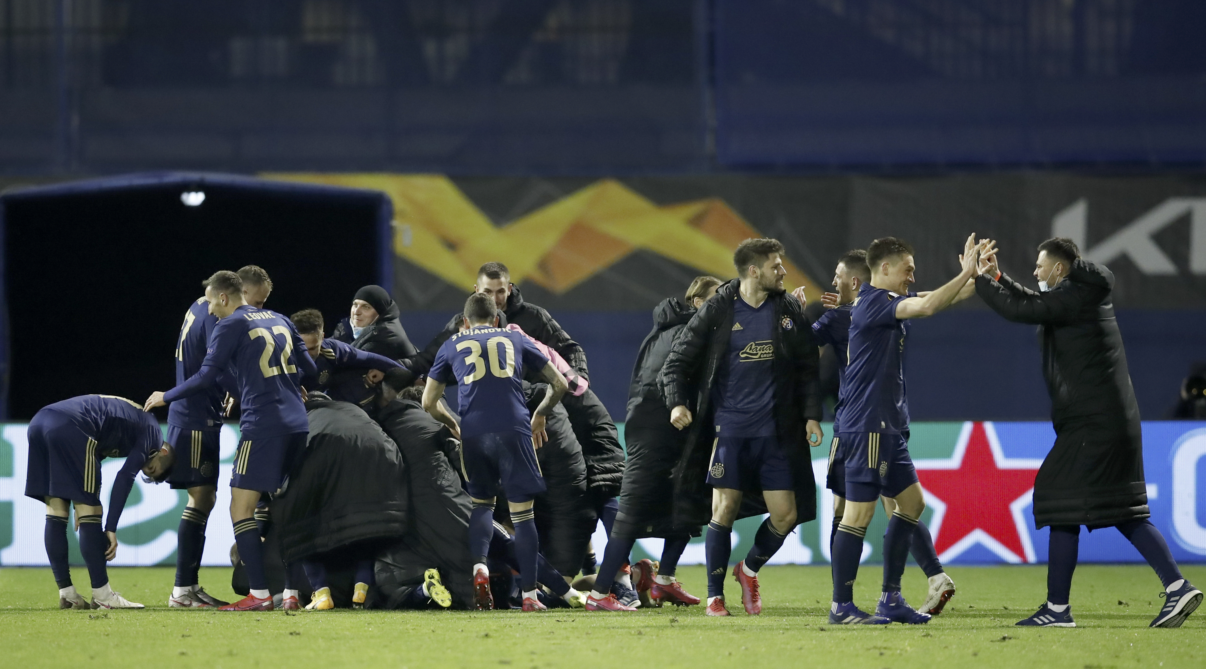 epa09082832 Players of Zagreb celebrate the 3-0 lead during the UEFA Europa League Round of 16, second leg match between Dinamo Zagreb and Tottenham Hotspur in Zagreb, Croatia, 18 March 2021.  EPA-EFE/ANTONIO BAT