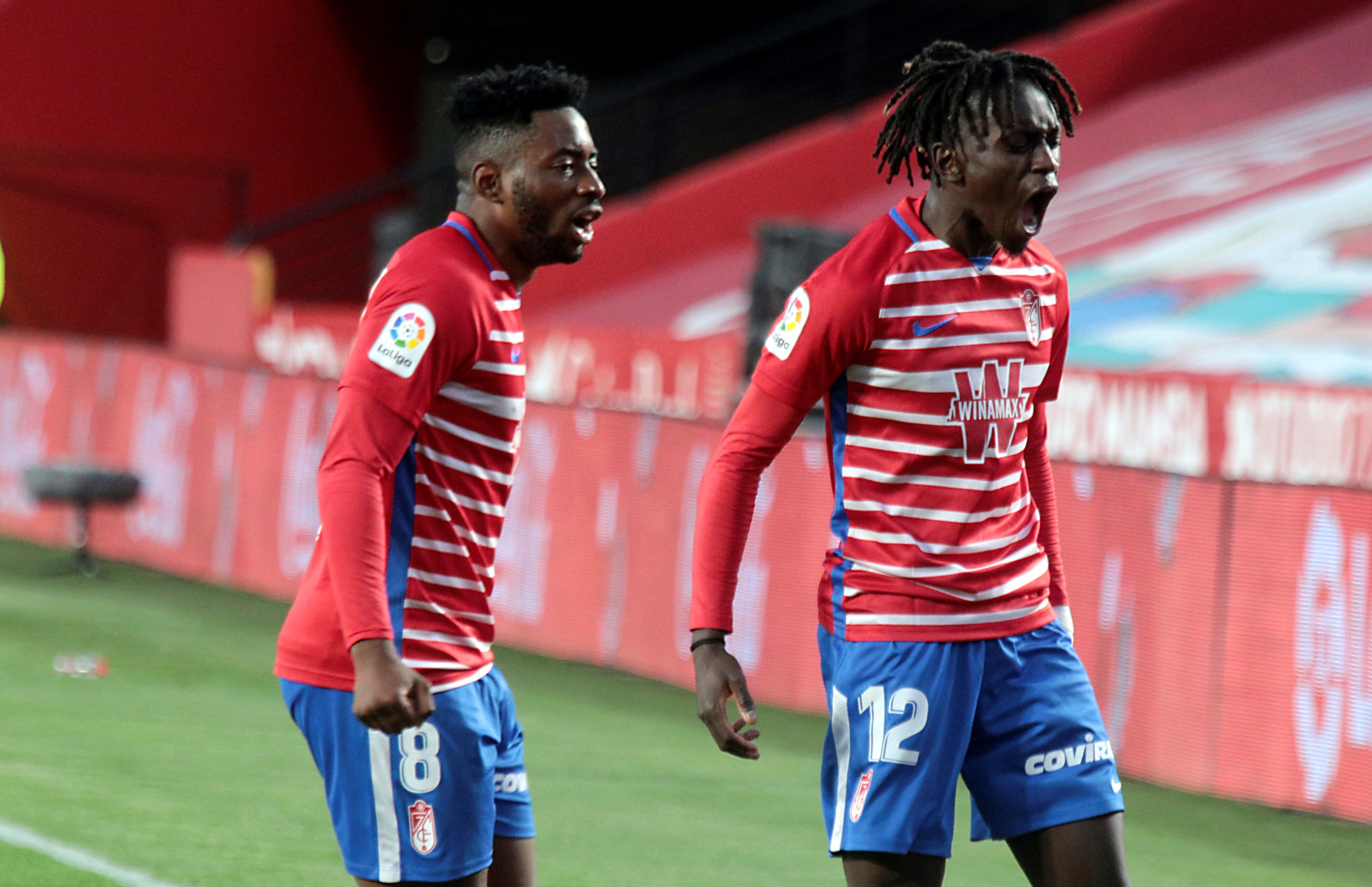 epa09043361 Granada's Domingos Quina (R) celebrates after scoring the 1-0 goal during a Spanish LaLiga soccer match between Granada CF and Elche at Nuevo Los Carmenes stadium in Granada, Spain, 28 February 2021.  EPA-EFE/PEPE TORRES
