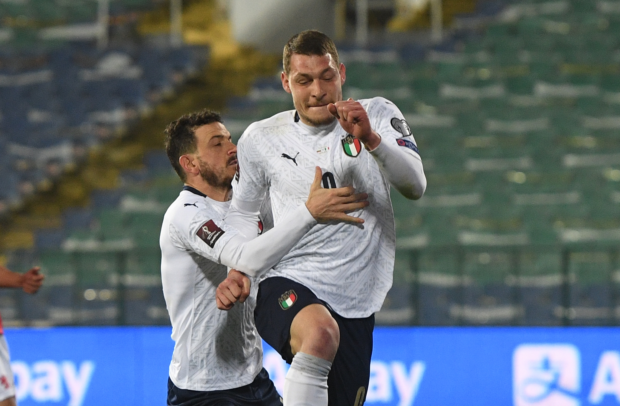epa09103786 Italy's Andrea Belotti (R) celebrates with team-mate Alessandro Florenzi after scoring a penalty goal during the FIFA World Cup 2022 qualifying soccer match between Bulgaria and Italy in Sofia, Bulgaria, 28 March 2021.  EPA-EFE/VASSIL DONEV