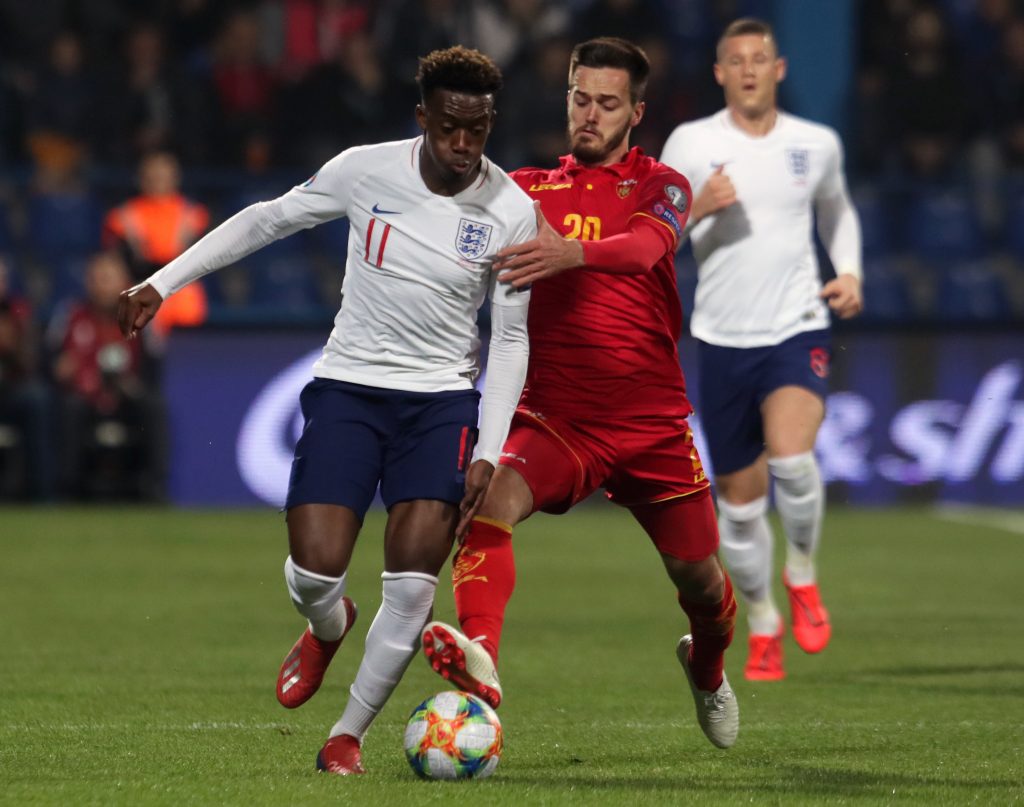 epa07463429 England's Callum Hudson-Odoi (L) in action against Montenegro's Mirko Ivanic (R) during the UEFA EURO 2020 qualifier soccer match between Montenegro and England in Podgorica, Montenegro, 25 March 2019.  EPA-EFE/KOCA SULEJMANOVIC