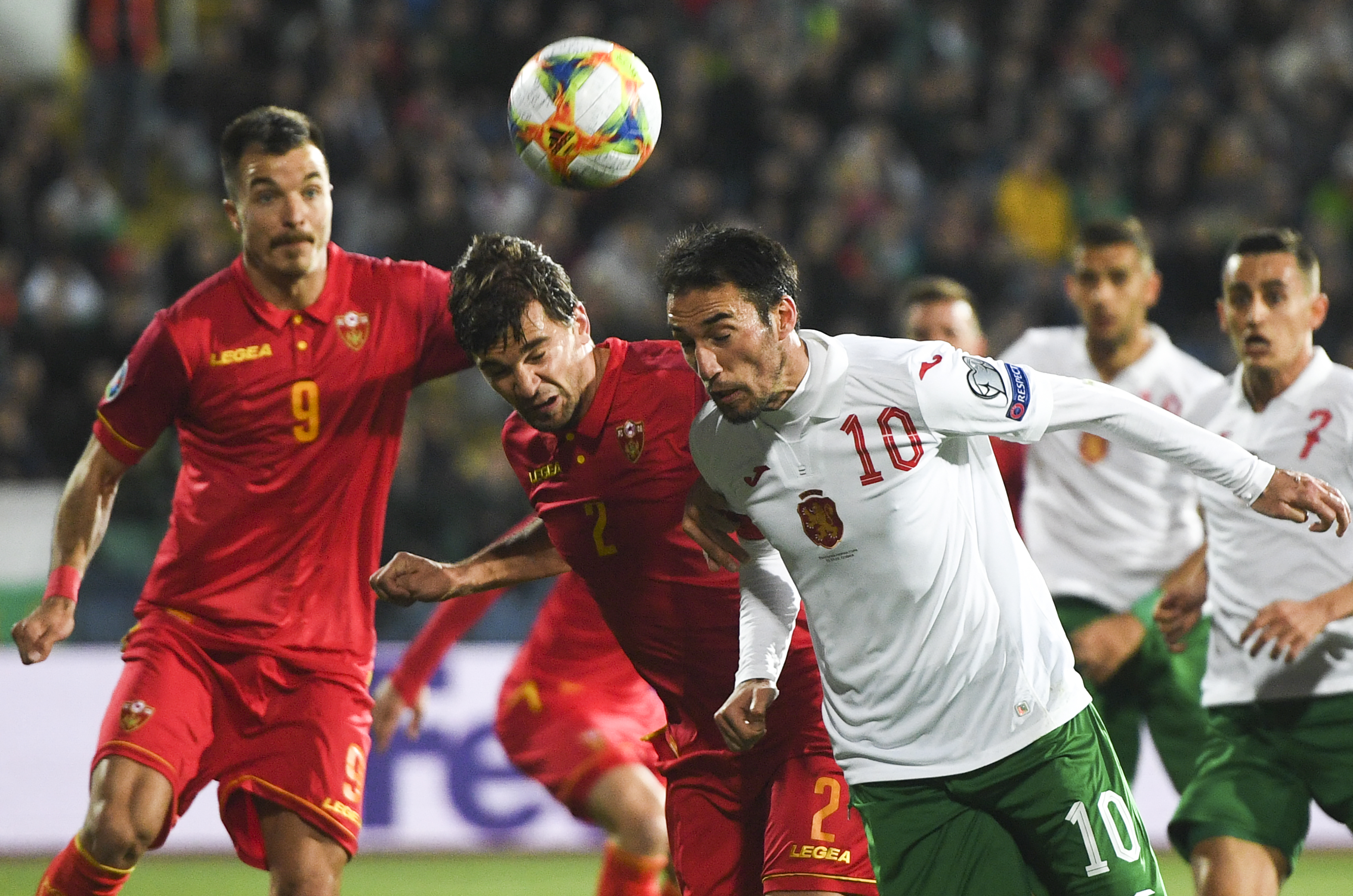 epa07456508 Ivelin Popov (R) of Bulgaria in action against Filip Stojkovic (C) of Montenegro during the UEFA EURO 2020, Group A qualifying soccer match between Bulgaria and Montenegro in Sofia, Bulgaria, 22 March 2019.  EPA-EFE/VASSIL DONEV